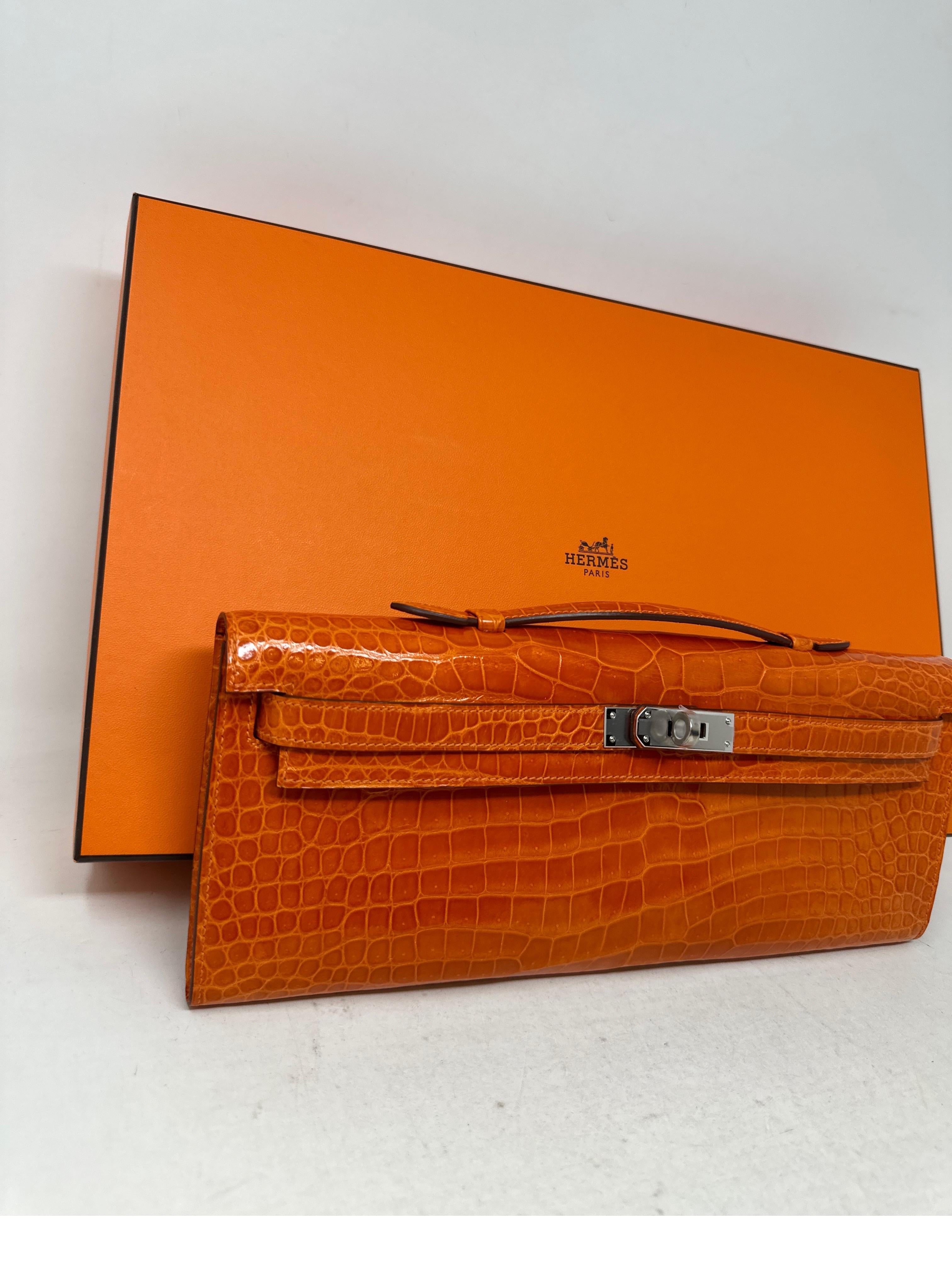 Hermes Orange Crocodile Kelly Cut Clutch. Beautiful shiny orange porosus crocodile with palladium hardware. R stamp. Excellent like new condition. Rare bag. Includes dust bag and box. Guaranteed authentic. Great deal. 