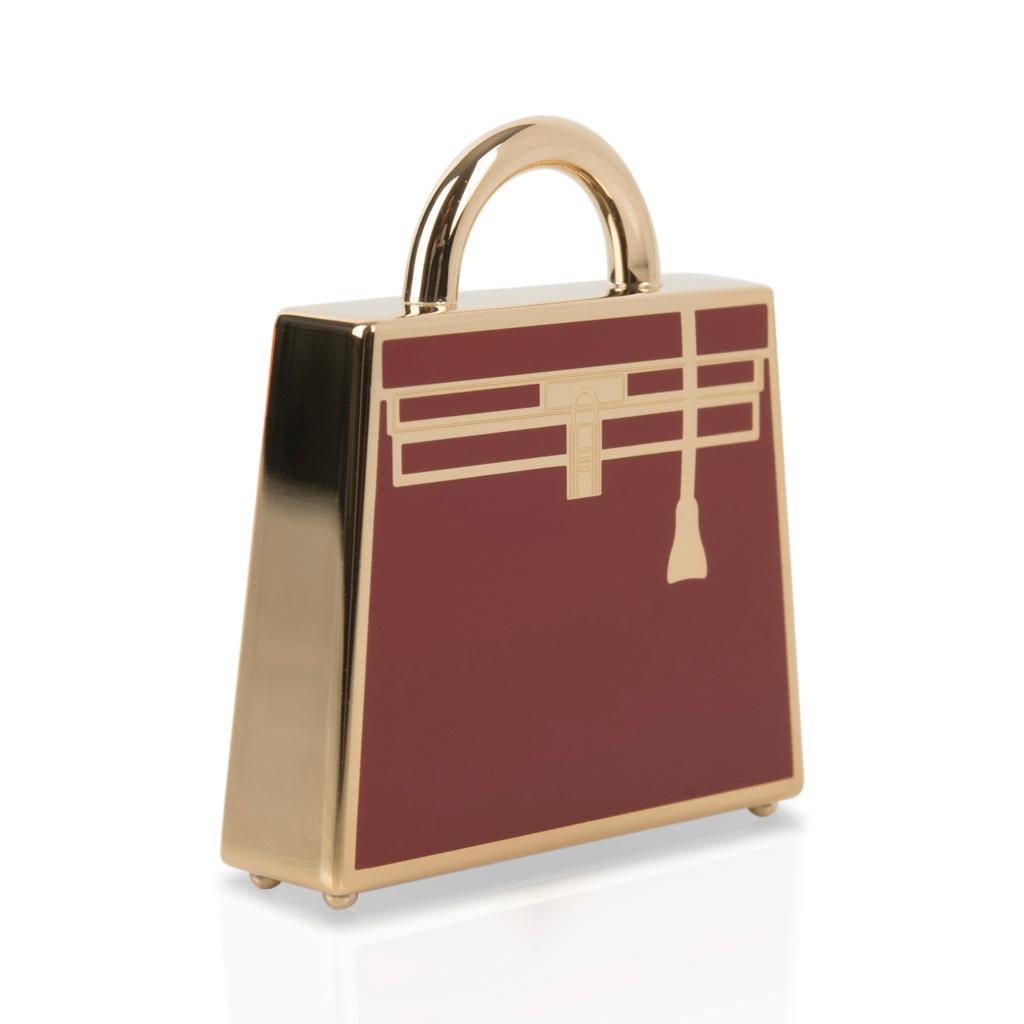 Guaranteed authentic Hermes Curiosite Kelly Laque Charm features features Rouge H with Permabrass.
Shaped like a Kelly Bag, the charm is beautifully detailed!
Designed as a necklace pendant, and can also be worn tied to an Hermes Twilly as a