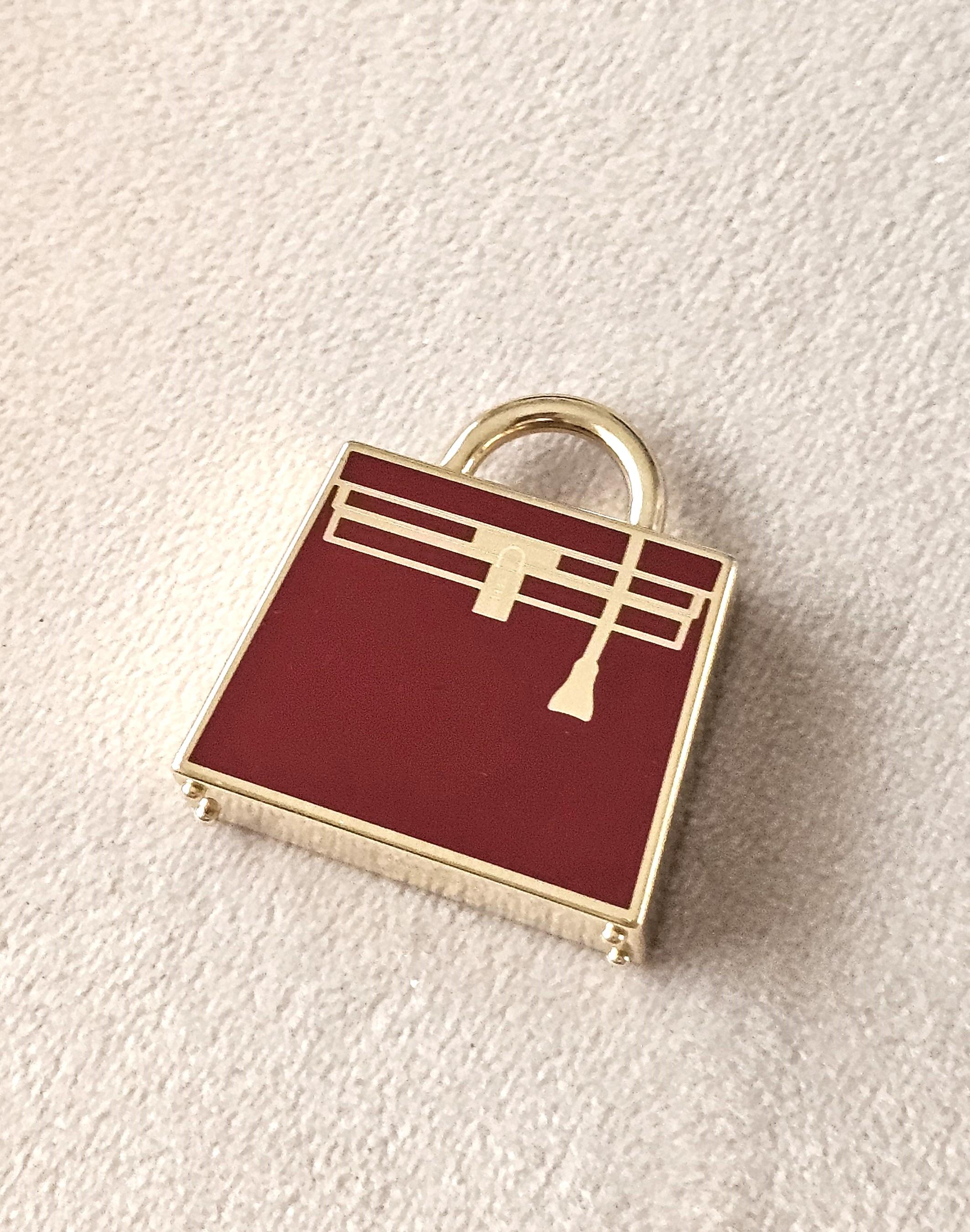 Charm Hermès Permabrass - A forma di borsa Kelly, ciondolo o charm Twilly

Questo squisito charm, a forma dell'iconica borsa Hermès Kelly, è splendidamente dettagliato e progettato per fungere sia da ciondolo per una collana che da affascinante