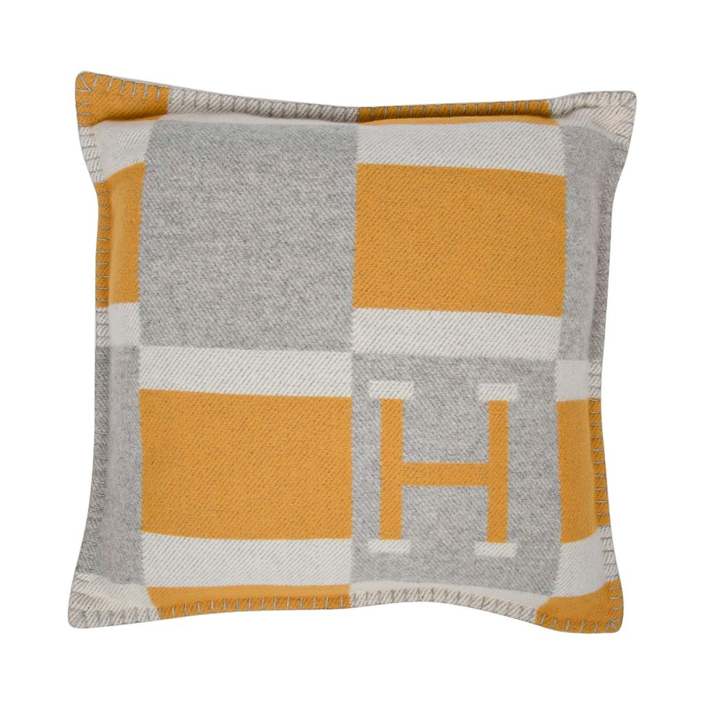 Guaranteed authentic Hermes small model Avalon Bayadere pillow features the iconic H in Jaune, Gris and Ecru.
The removable cover is created from 90% Wool and 10% cashmere and has whip stitch edges.
New or Pristine Store Fresh Condition.  
Comes