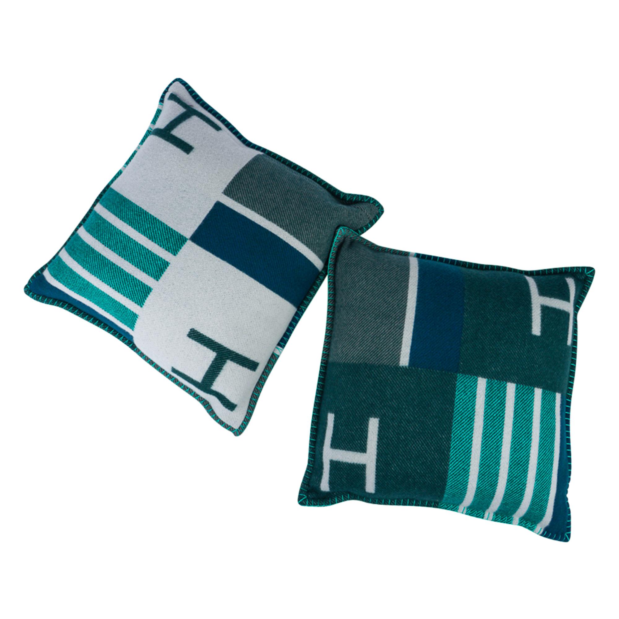 Guaranteed authentic Hermes small model Avalon Vibrato limited edition pillows with the iconic H in gorgeous tones of  Vert accentuated with blue.
Set of two. 
The removable cover is created from 90% Wool and 10% cashmere and has whip stitch
