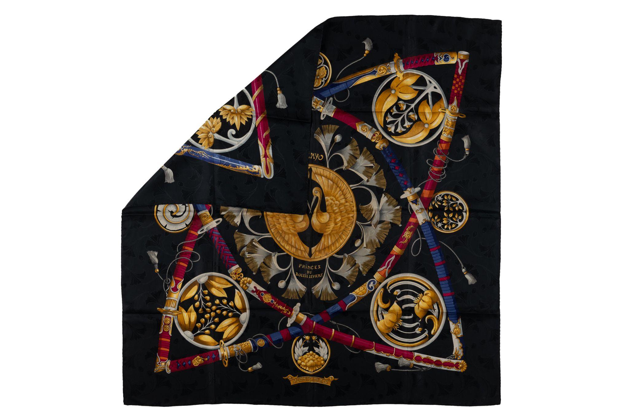 This Hermès Silk Daimyo Princes du Soleil Levant Scarf is made from 100% and hand-rolled edges. It features a black background with an array of golden Japanese samurai swords and medallions. It comes with no label and no box.