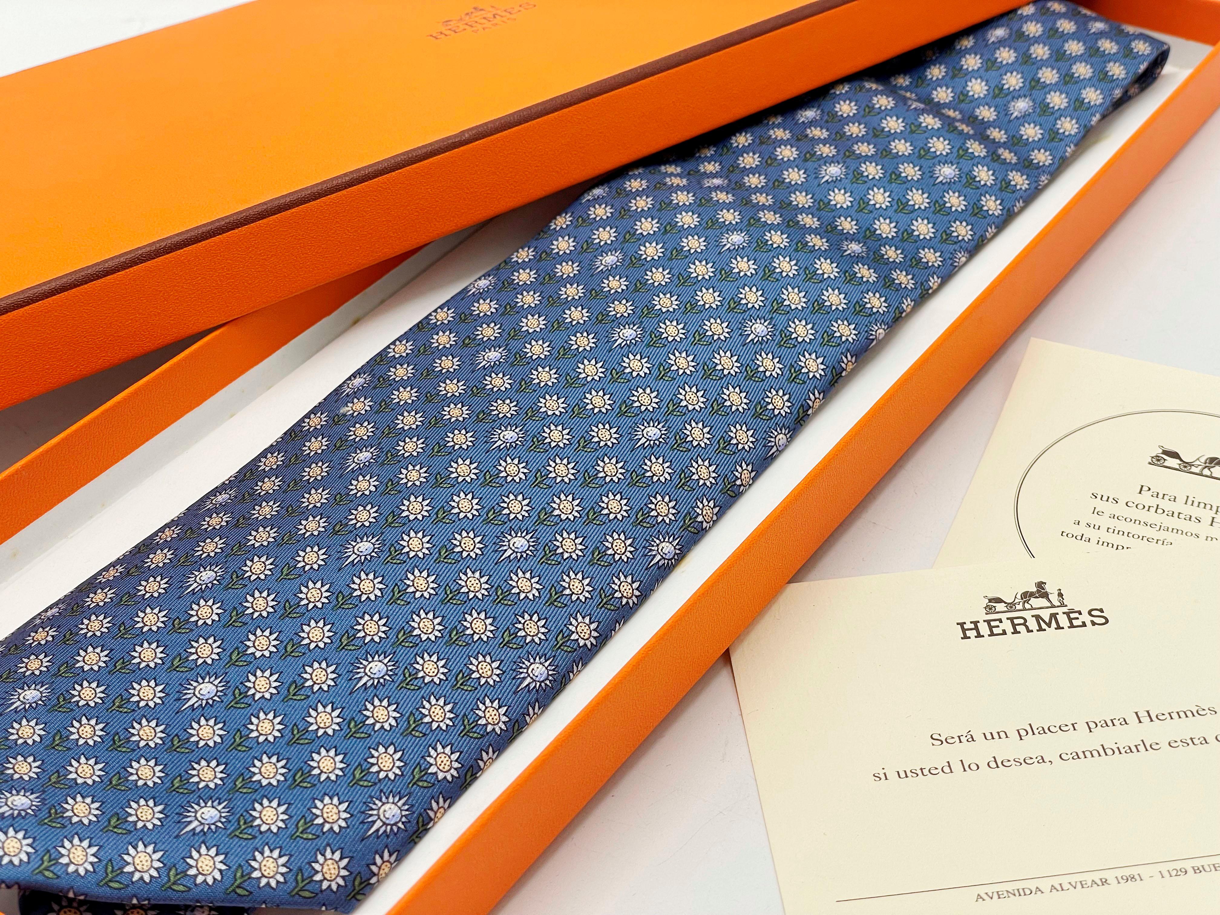 Authentic Hermes funny and charming tie with original box, tissue and ribbon. Blue silk with daisy print. 
Excellent, like new condition. 
Made in France. 5074 PA.
Tie in hand-sewn heavy silk (100% silk)

Width: 9 centimeters 
Length: 148