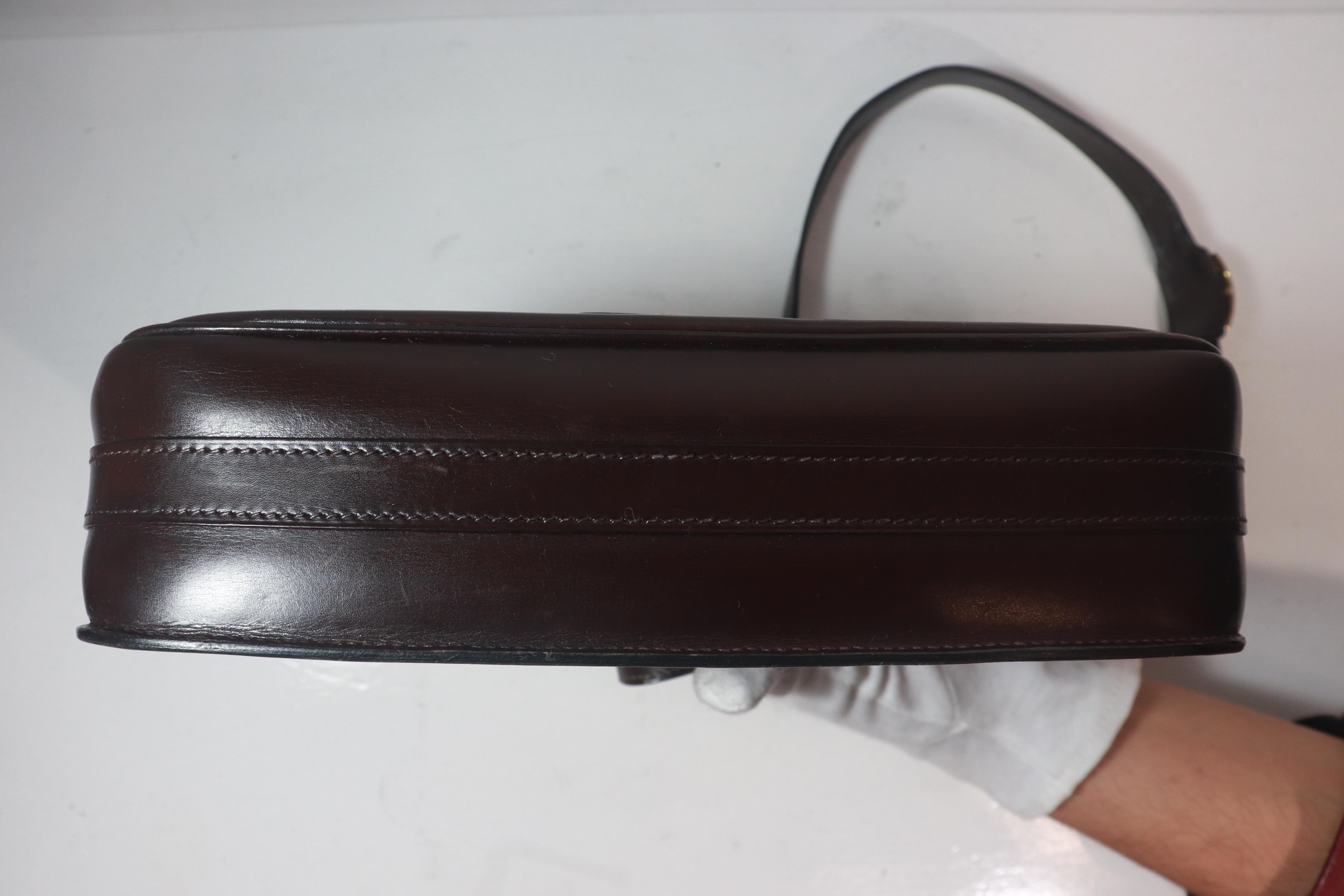 Women's HERMÈS Dark Brown Leather Crossbody Bag with Gold Buckle and Adjustable Strap For Sale