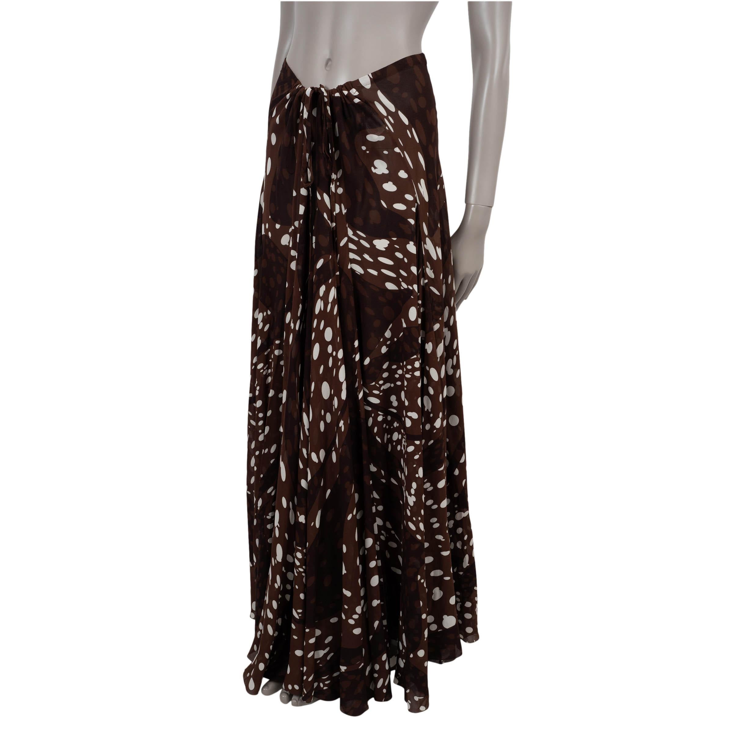 This 100% authentic Hermès skirt is crafted in chocolate brown chiffon silk with an allover white dotted print. The airy, flared silhouette falls to a midi length and ties at the front with a drawstring closure for a customizable fit. Unlined for