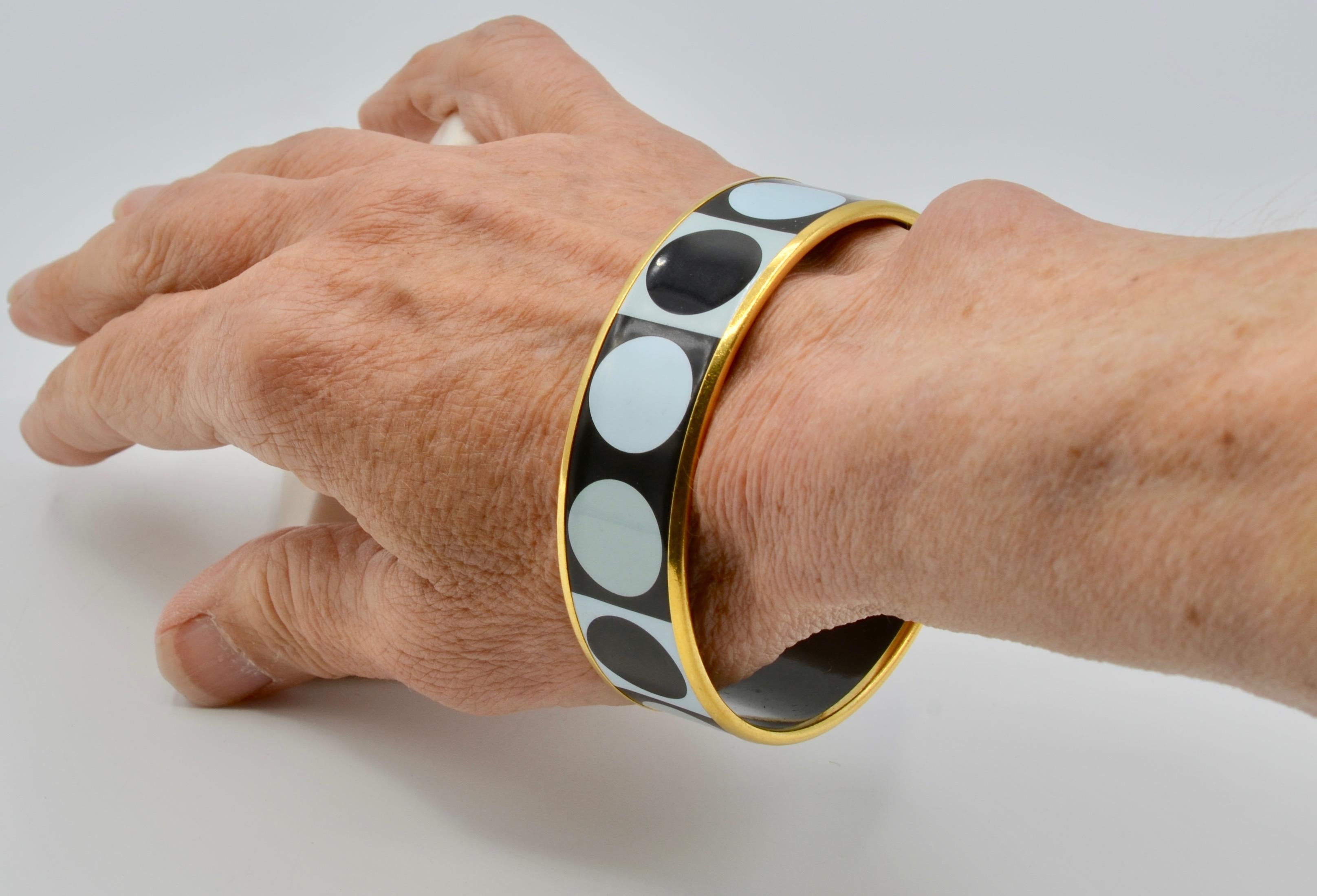 This iconic Hermes black and white Deco dot is a classic among the collection. The versatility and neutral color combination is the perfect addition to any collection. It can be paired with vibrant colors or stand alone in an all black or all white