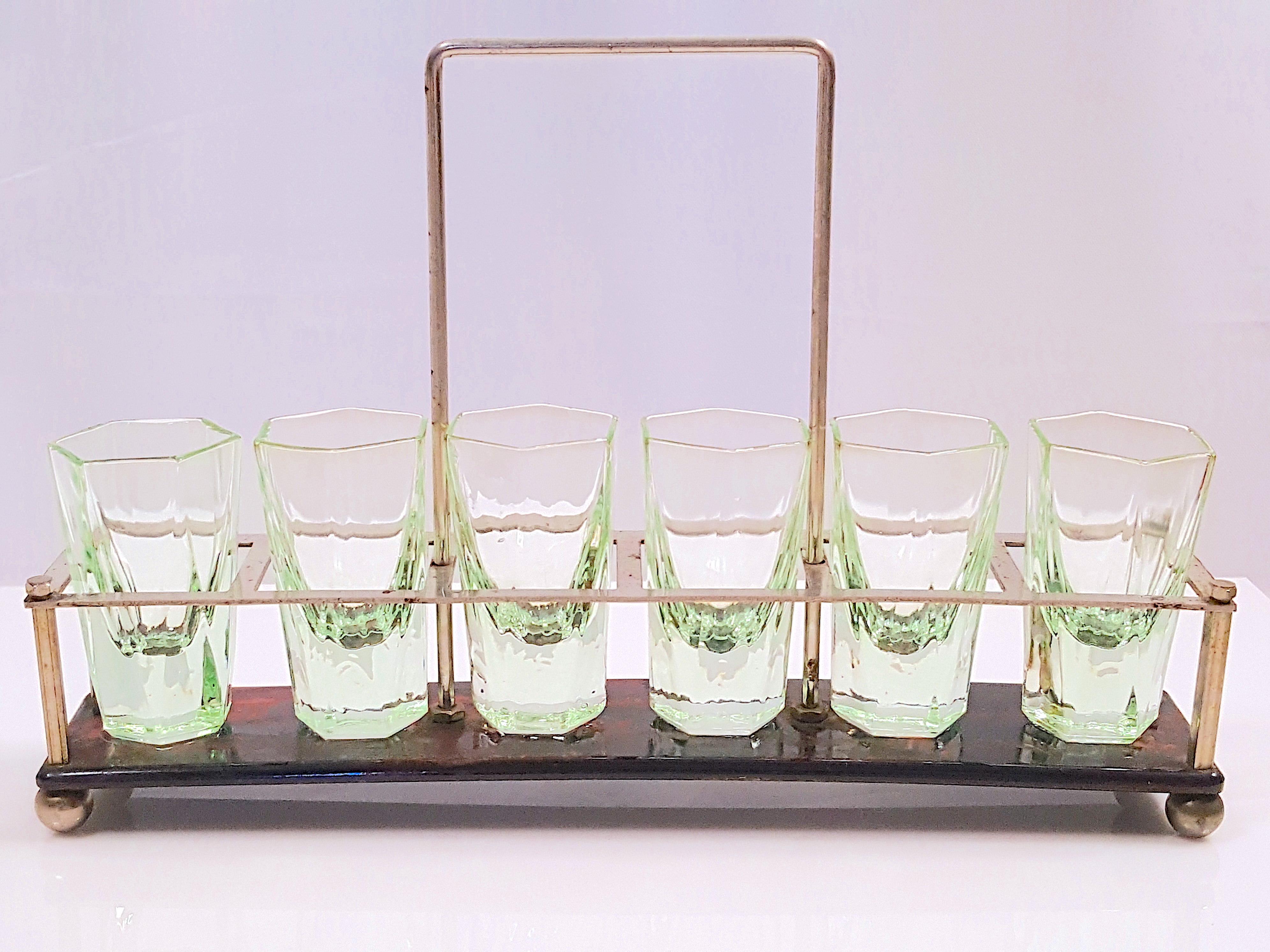 With characteristic combination of materials, construction, and sleek shape by French designer Jacques Adnet before he gained fame designing furnishings for Parisian luxury fashion house Hermes, this ArtDeco-period bar set with 1920s color-palette