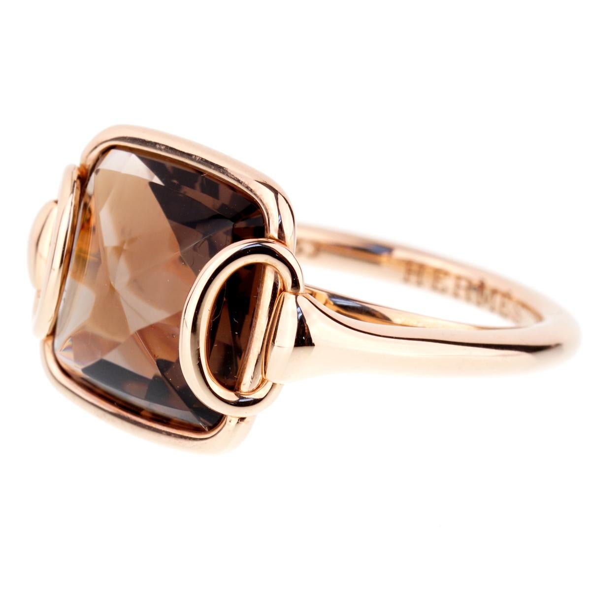 A chic Hermes ring from the Deux Anneaux featuring a Smoky Quartz wrapped in luxurious 18k rose gold. The ring measures .55