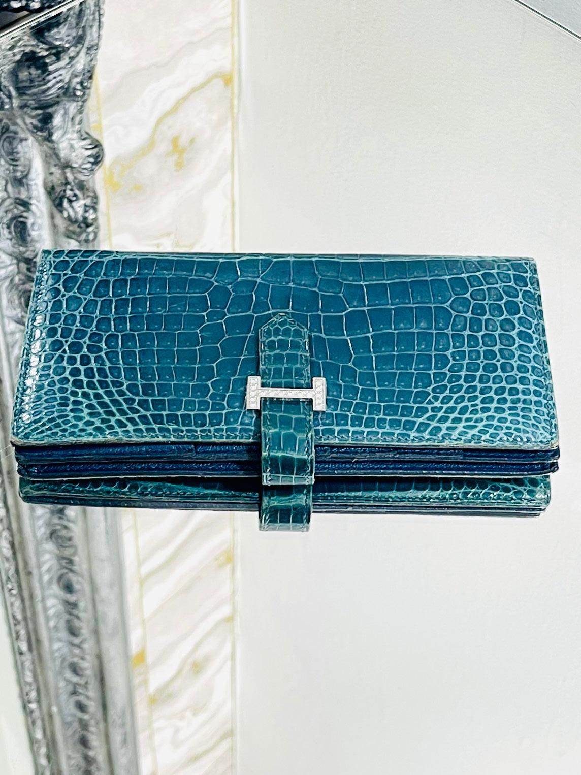 Hermes Diamond & 18k White Gold Shiny Crocodile Skin Bearn Wallet

Blue shiny Porosus Crocodile skin wallet with 

18k with gold 'H' closure that is fully adorned with 0.8cts of brilliant white 

diamonds. VS quality in S/G colour diamonds.

The