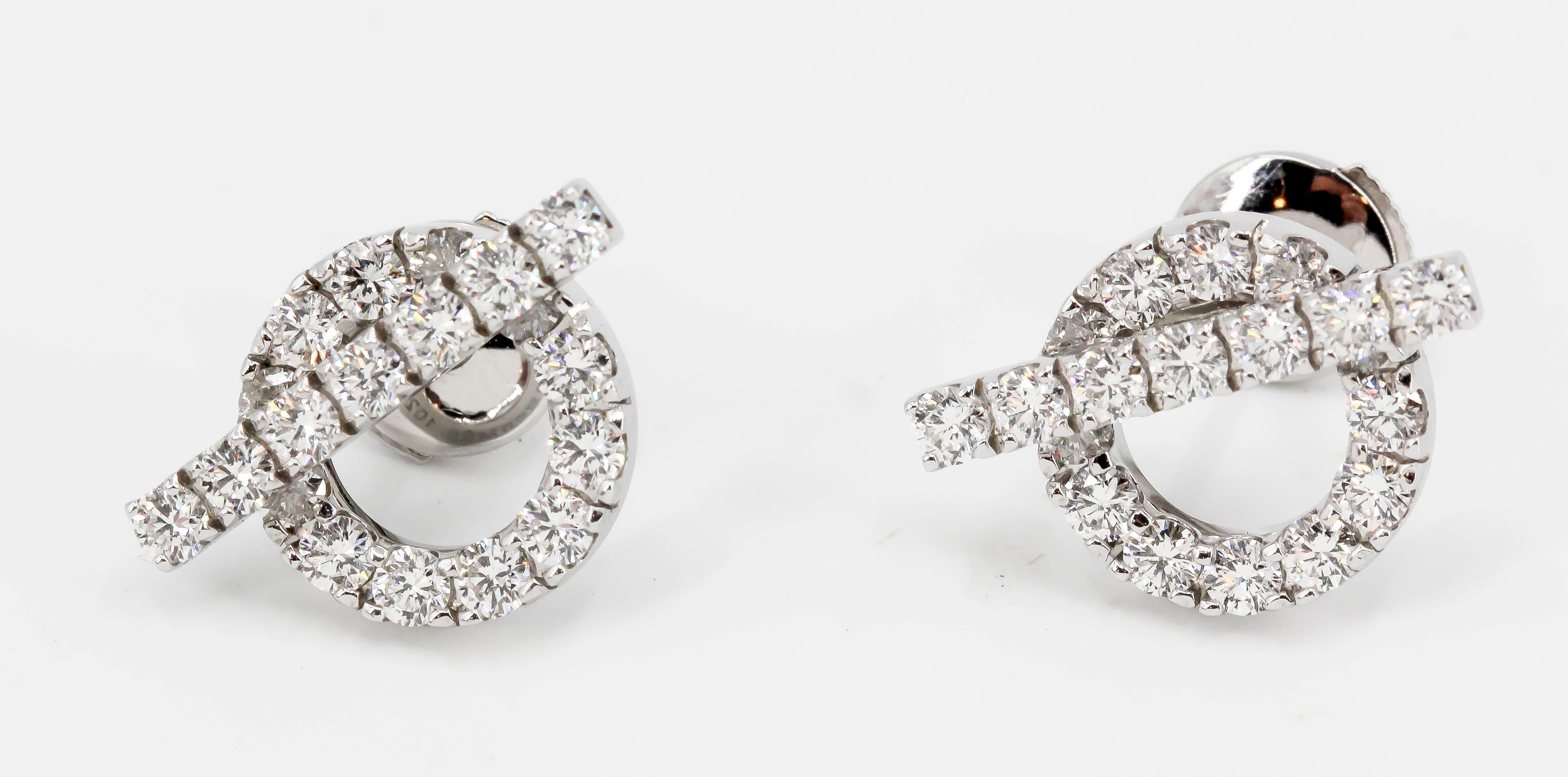 Elegant diamond and 18K white gold earrings by Hermes. They resemble toggles and feature high grade round brilliant cut diamonds over a white gold setting.

Hallmarks: Hermes, reference numbers, Au 750, 