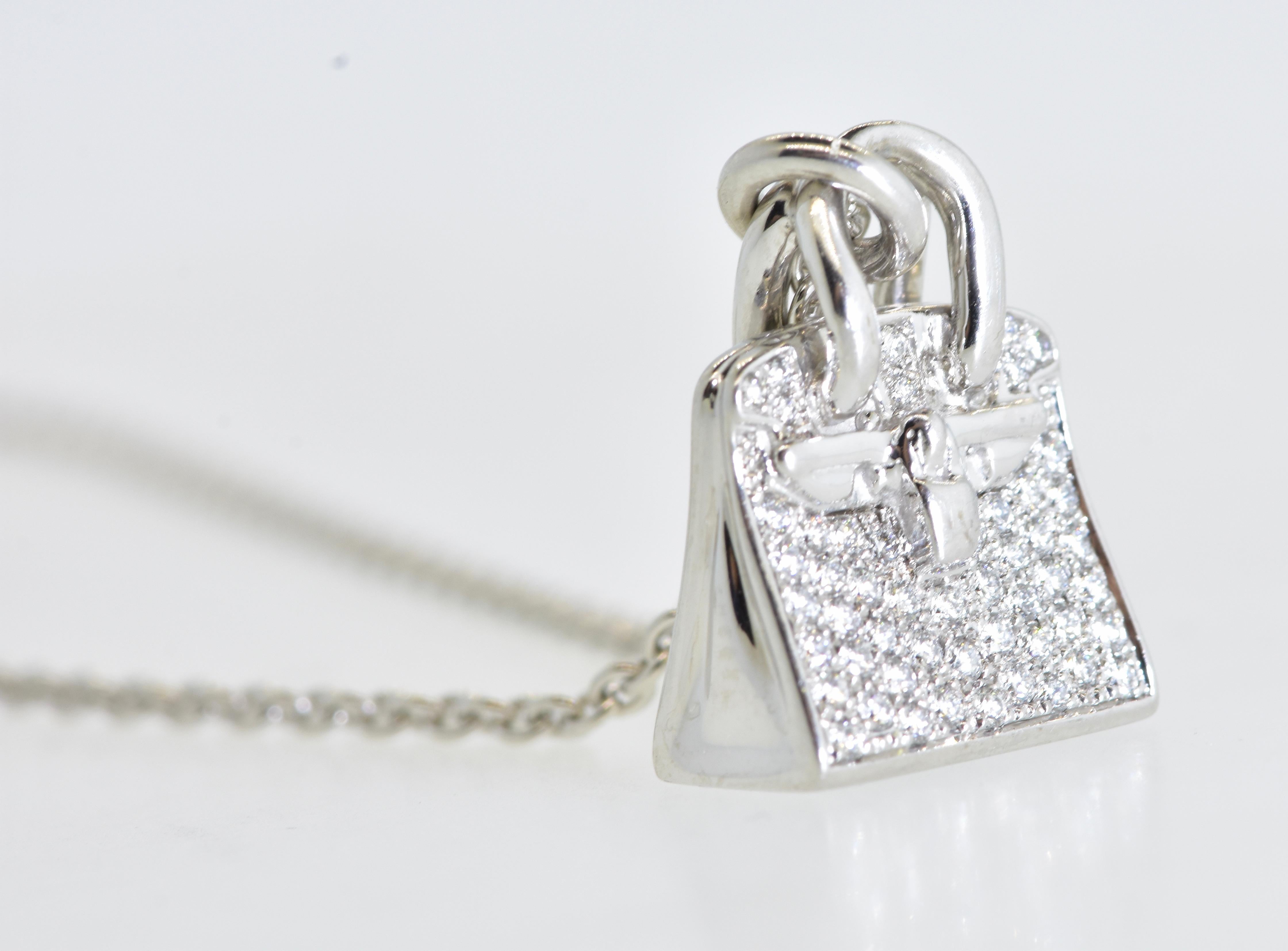 Hermes diamond and 18K white gold Birkin Amulette pendant necklace with 51 well cut and well matched brilliant cut diamonds all near colorless (G), and very slightly included, amounting to a diamond weight of .22 cts.  This piece is signed Hermes,