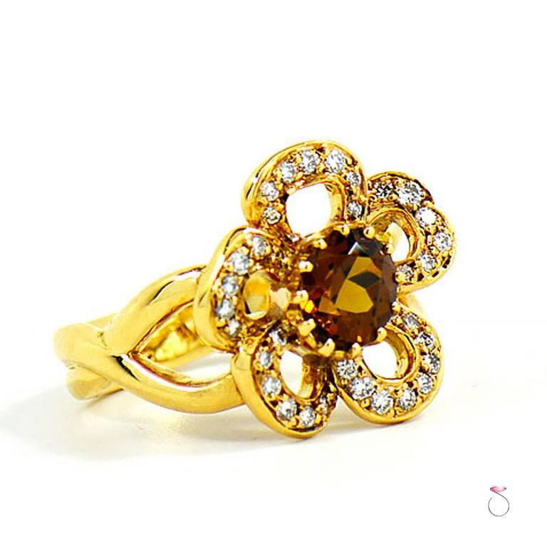 Hermes Citrine and Diamond flower ring Blooming with beauty and elegance. The center of the flower is set with a beautiful yellowish brown Citrine, surrounded by the flower petals set with round brilliant diamonds in 18k yellow gold. This stunning
