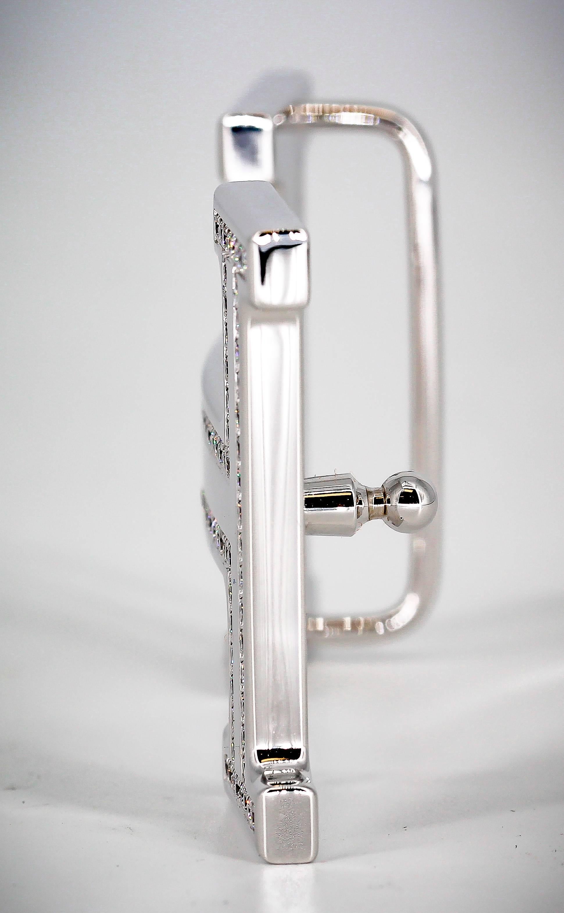 Stunning diamond and 18K white gold belt buckle by Hermes. It features the letter 