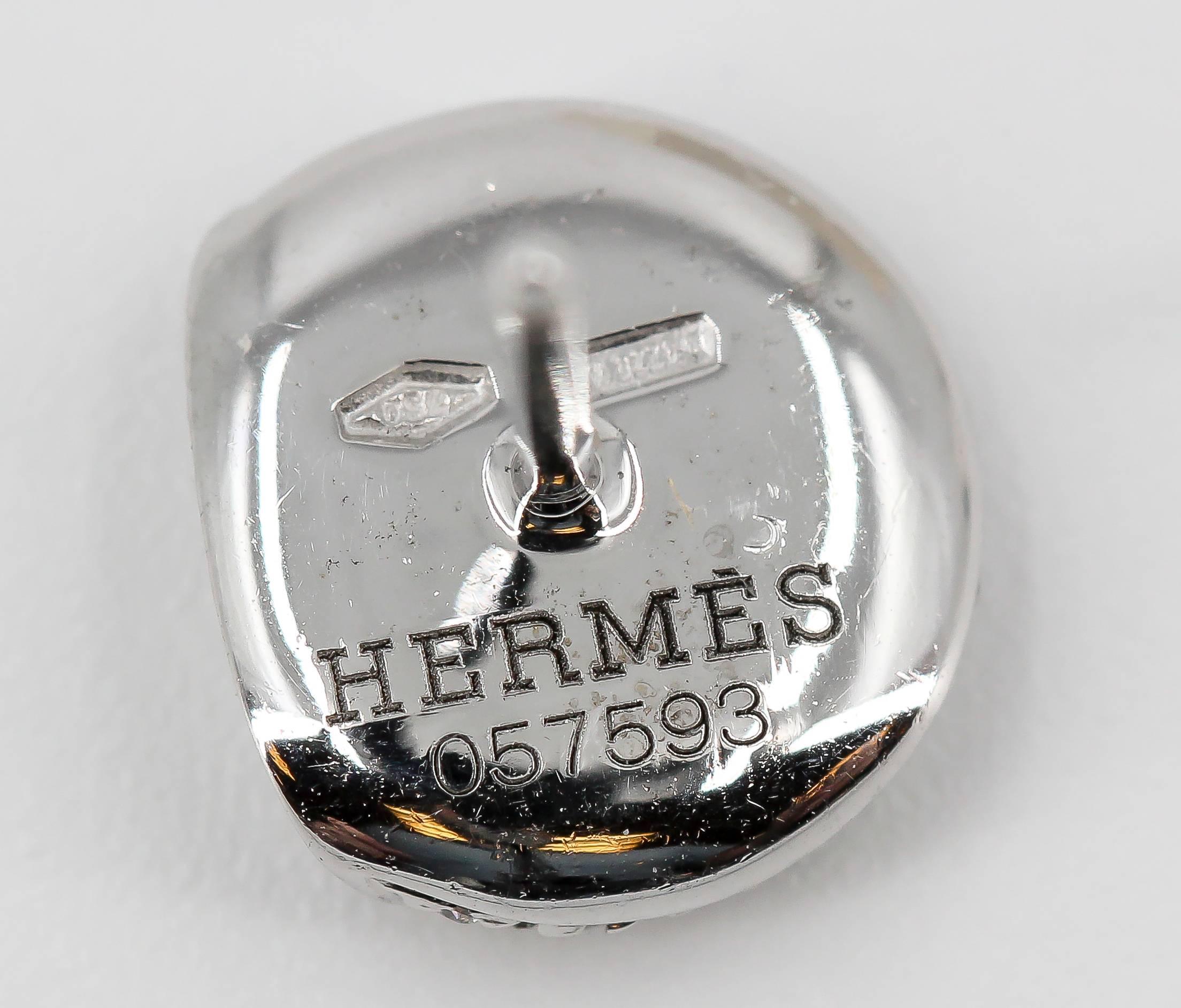 Current diamond and 18K white gold stud earrings by Hermes. They feature high grade round brilliant cut diamonds throughout.

Hallmarks: Hermes, reference numbers, maker's mark, French 18K gold assay mark.