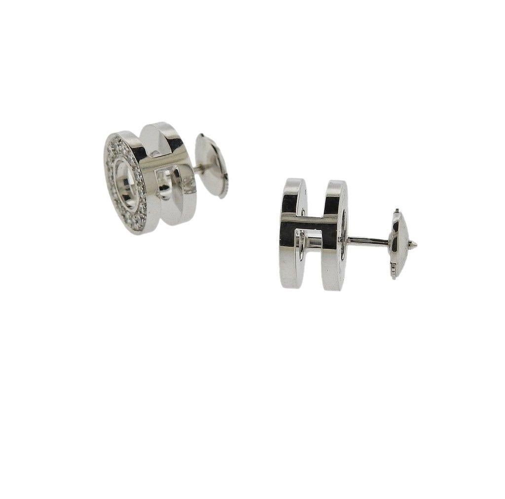  Pair of 18k white gold circle stud earrings, crafted by Hermes, decorated with approximately 0.30ctw in diamonds. Retail $5500. Earrings are 12mm in diameter and weigh 9.2 grams. 