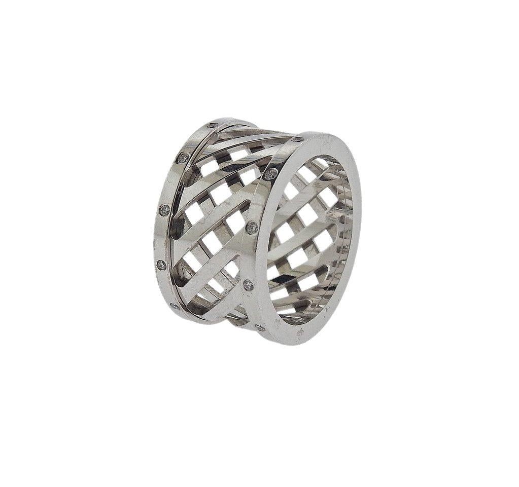  An 18k white gold wide band ring by Hermes, featuring woven pattern, decorated with approximately 0.13ctw in diamonds. Retail $5500. Ring size - 7, ring top - 12.1mm wide, weighs 12.9 grams. Marked: French mark, 0710319, 54, Hermes, Au750.