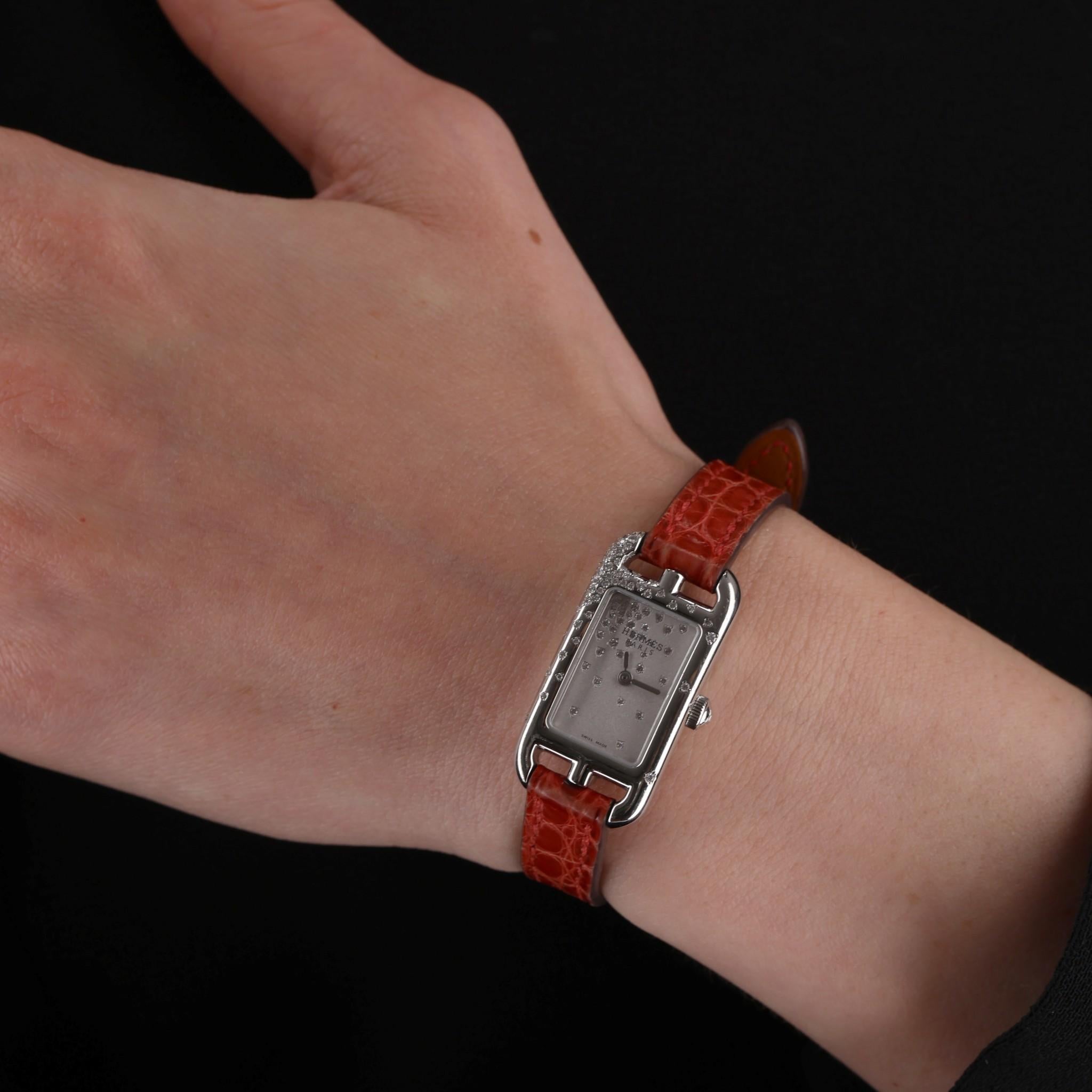 Hermes Diamond Nantucket Watch With Alligator Strap 

Flaunting brilliant white diamonds to the stainless steel case and the face. 

Set with 55 diamonds totalling 30cts. Bright red Alligator strap.

Quartz movement and pink buckle clasp closure.