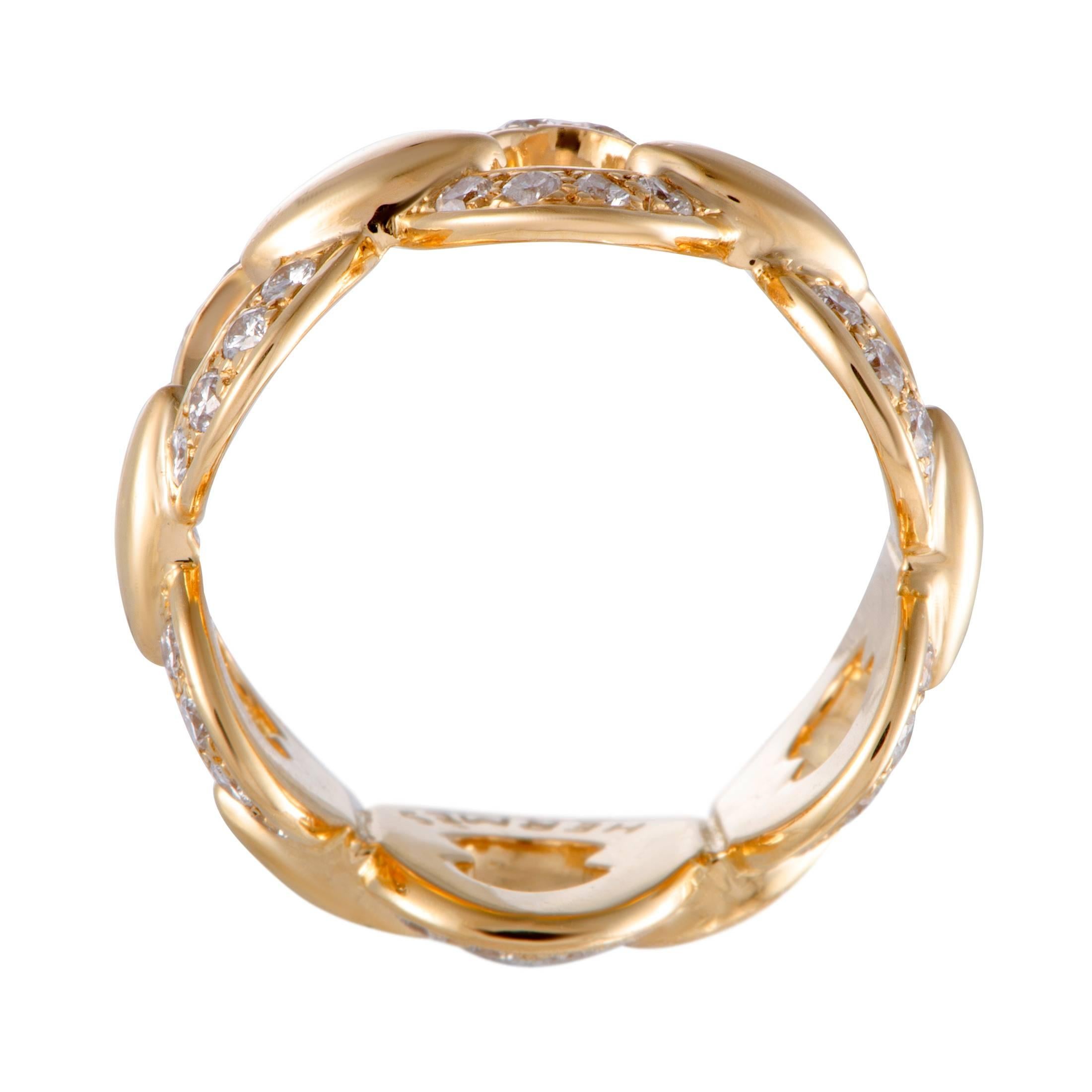 Style and elegance are embodied in this gorgeous 18K yellow gold ring by Hermès. The sensational ring's design sparkles with a stunning pave of sparkling diamonds, weighing 0.75ct, that reflects the luxurious value of the beautiful piece.
Band