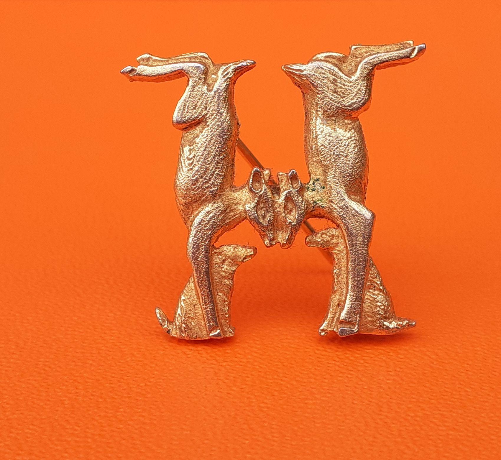 Beautiful Authentic Hermès Brooch

Pattern: dogs and hinds forming an H

We can find this pattern on the Hermès Scarf called 