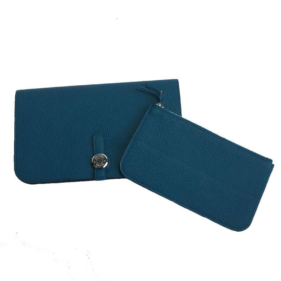 Hermes Dogon duo combined wallet, large model, in blue (Colvert) togo leather lined in lambskin. Palladium plated 'Clou de Selle' closure

It contains a zipped purse, removable. 5 credit card slots, 2 multifunctional bellows.

Made in France. Never