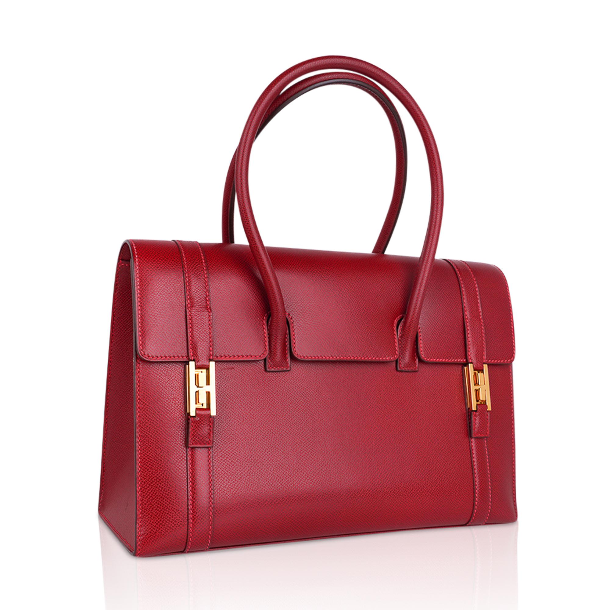 One of the most elegant bags Hermes ever produced in the most gorgeous Hermes Red!
This Rouge Vif beauty is the original production of the Hermes Drag Bag. 
This coveted red is not being produced and is loved with her pink top stitch.
Simply