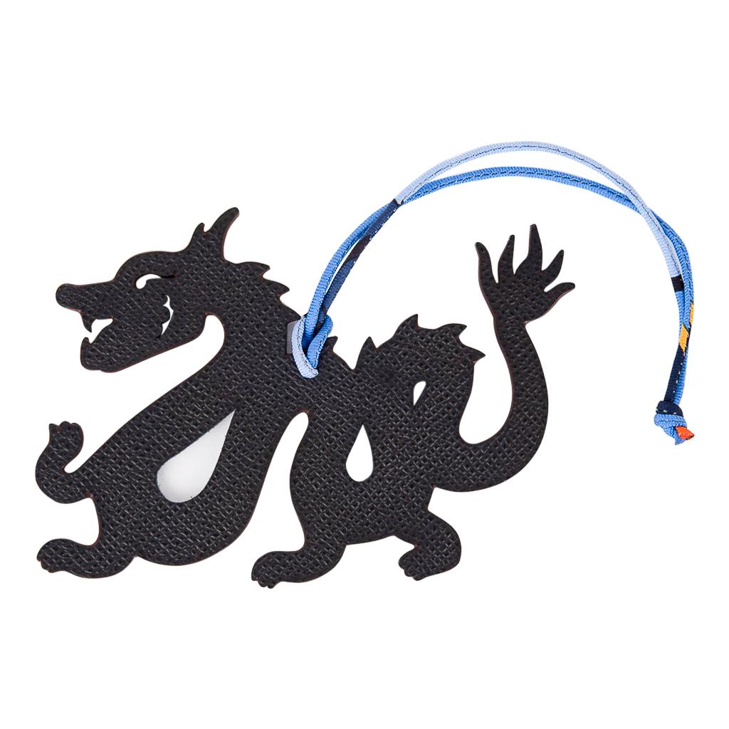 Guaranteed authentic very rare limited edition Hermes Petit h bi-color Dragon bag charm with silk twill cord.
This was a special limited edition for the petit H exhibit in Seoul.
This whimsical charm is featured in Blue Togo and Black Epsom and can
