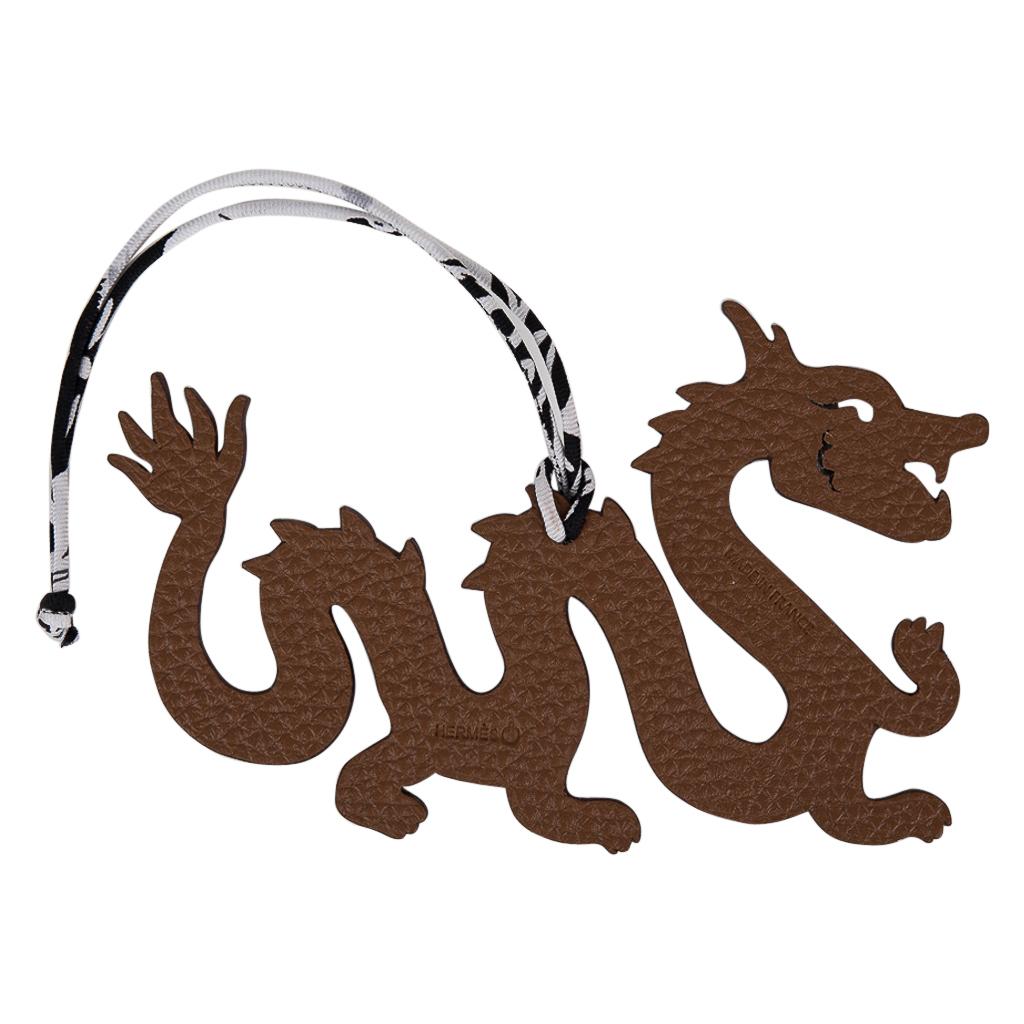 Guaranteed authentic very rare limited edition Hermes Petit h bi-color Dragon bag charm with silk twill cord.
This was a special limited edition for the petit H exhibit in Seoul.
This whimsical charm features  Brown Togo and Black Grain d'H