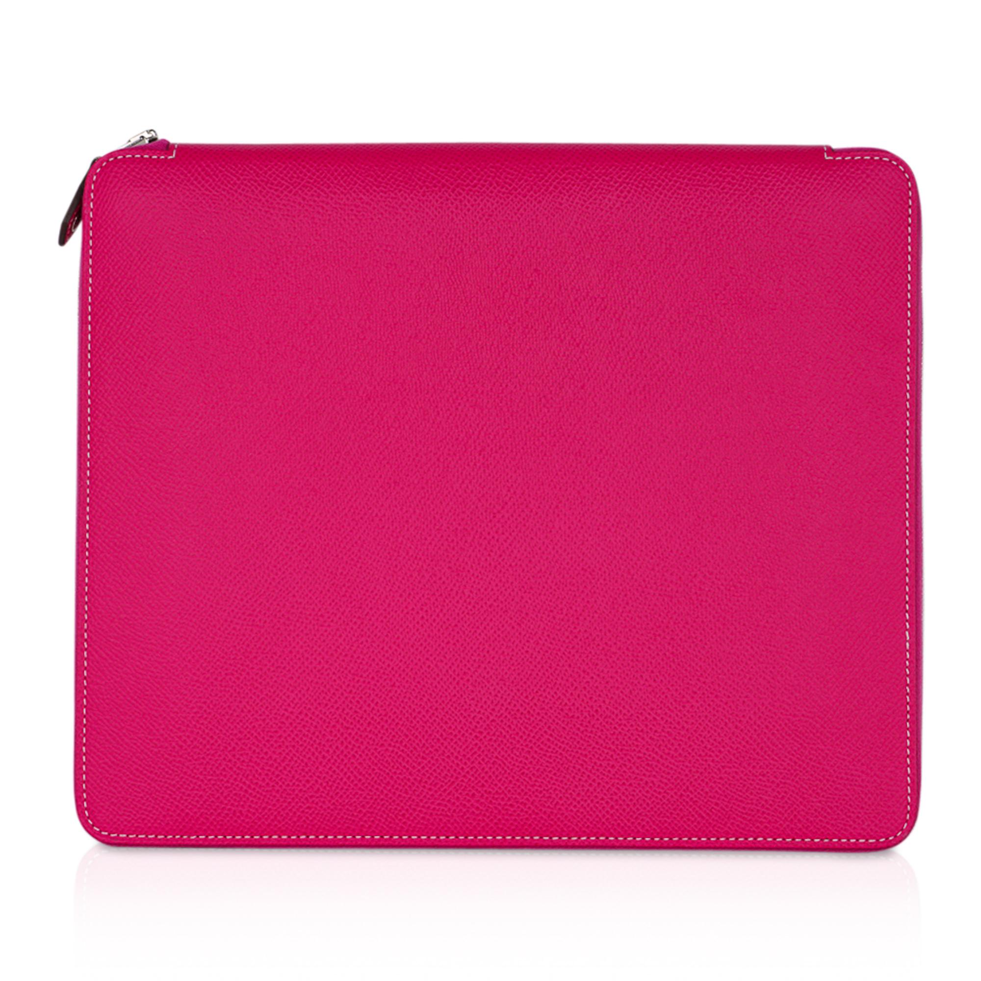 Mightychic offes a guaranteed authentic Hermes e-Zip iPad Notebook Cover featured in Rose Tyrien Epsom leather.
Case has leather lined hard center sleeve to hold iPad.
2 long slot pockets and 3 small slot pockets.
White top stitch.
New or Store