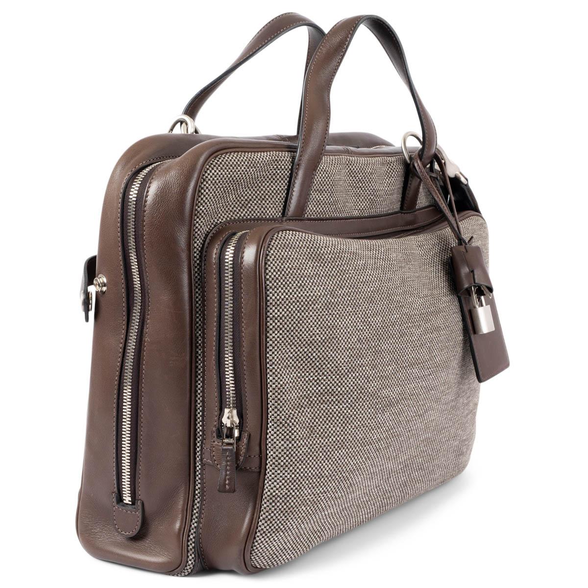 100% authentic Hermès Calèche-Express Messenger carry-on bag in taupe and black H Tech canvas with Ebene (dark brown) Veau Barenia leather trims. Features an exterior zip pocket on the front and an open pocket on the back, removable and adjustable