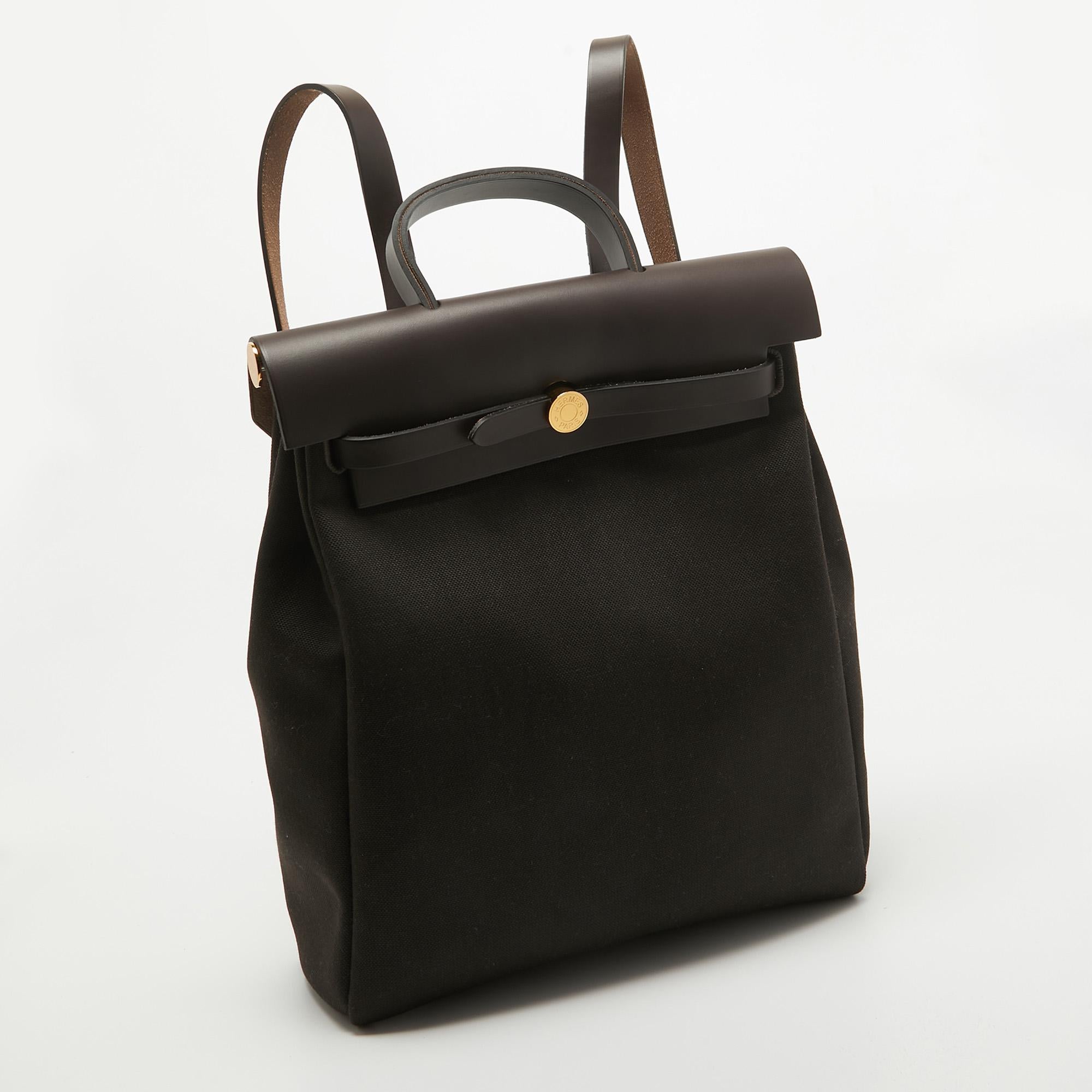The Hermès Herbag backpack is a stylish and versatile accessory that effortlessly combines functionality with luxury. Crafted with impeccable attention to detail, it features a durable canvas body with supple leather accents. The spacious interior,
