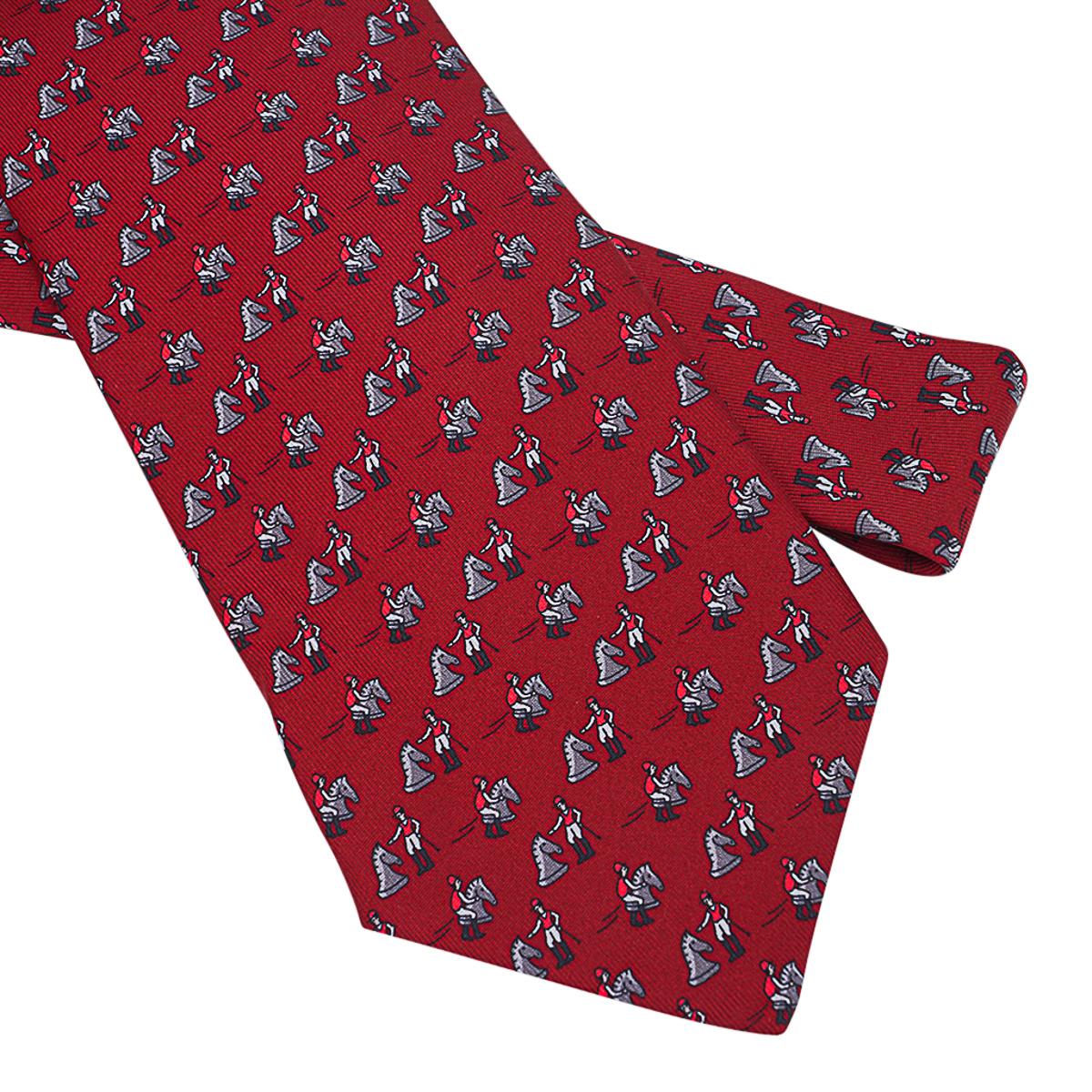 Mightychic offers an Hermes Echec Aux Jockey Twillbi silk tie featured in Carmin, Gris Fonce and Rouge colorway.
Charming depiction of the Jockey trying his hand at chess.
Designed by Philippe Mouquet.
Comes with signature Hermes tie sleeve.
NEW or