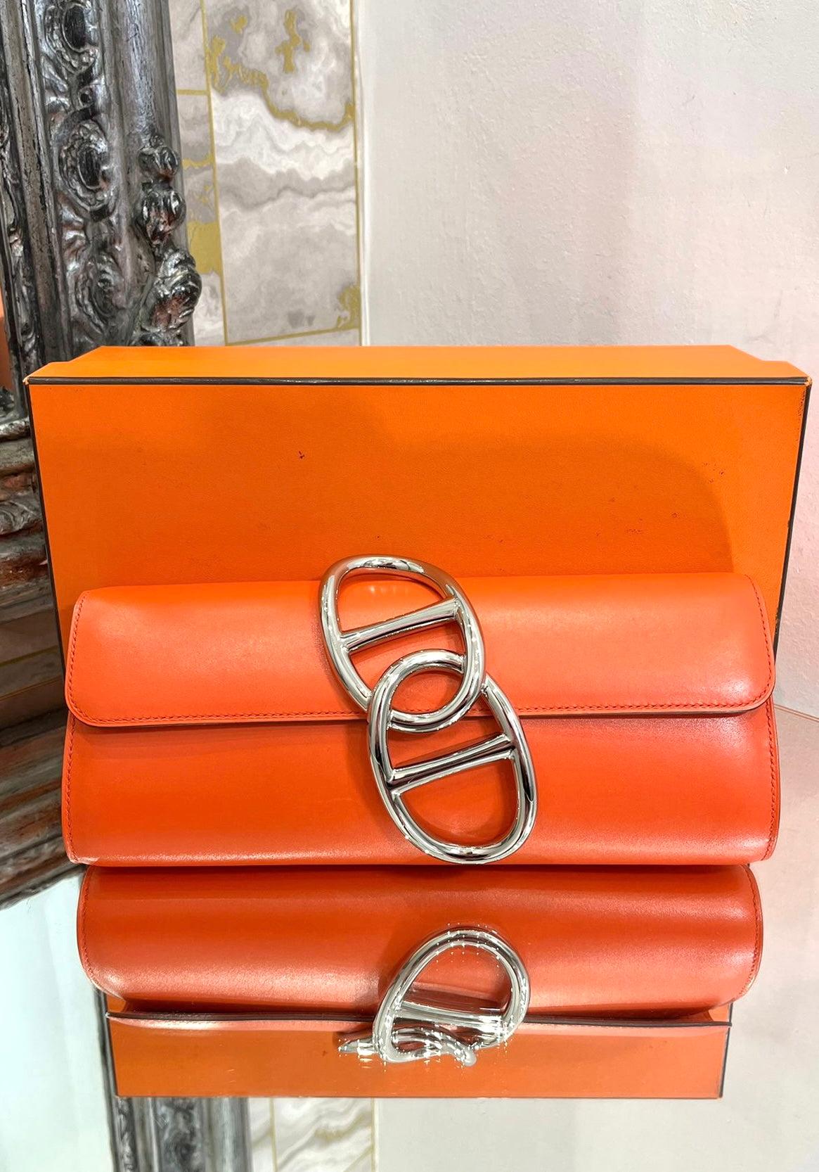 Hermes Egee Leather Clutch Bag

Hermes famous Orange, cylinder style bag with palladium iconic

signature Chaine D’Ancre feature to the front. Date code 2016.

Size - Height 10cm, Width 25cm, Depth 4cm

Condition - Very Good (Mark to leather where