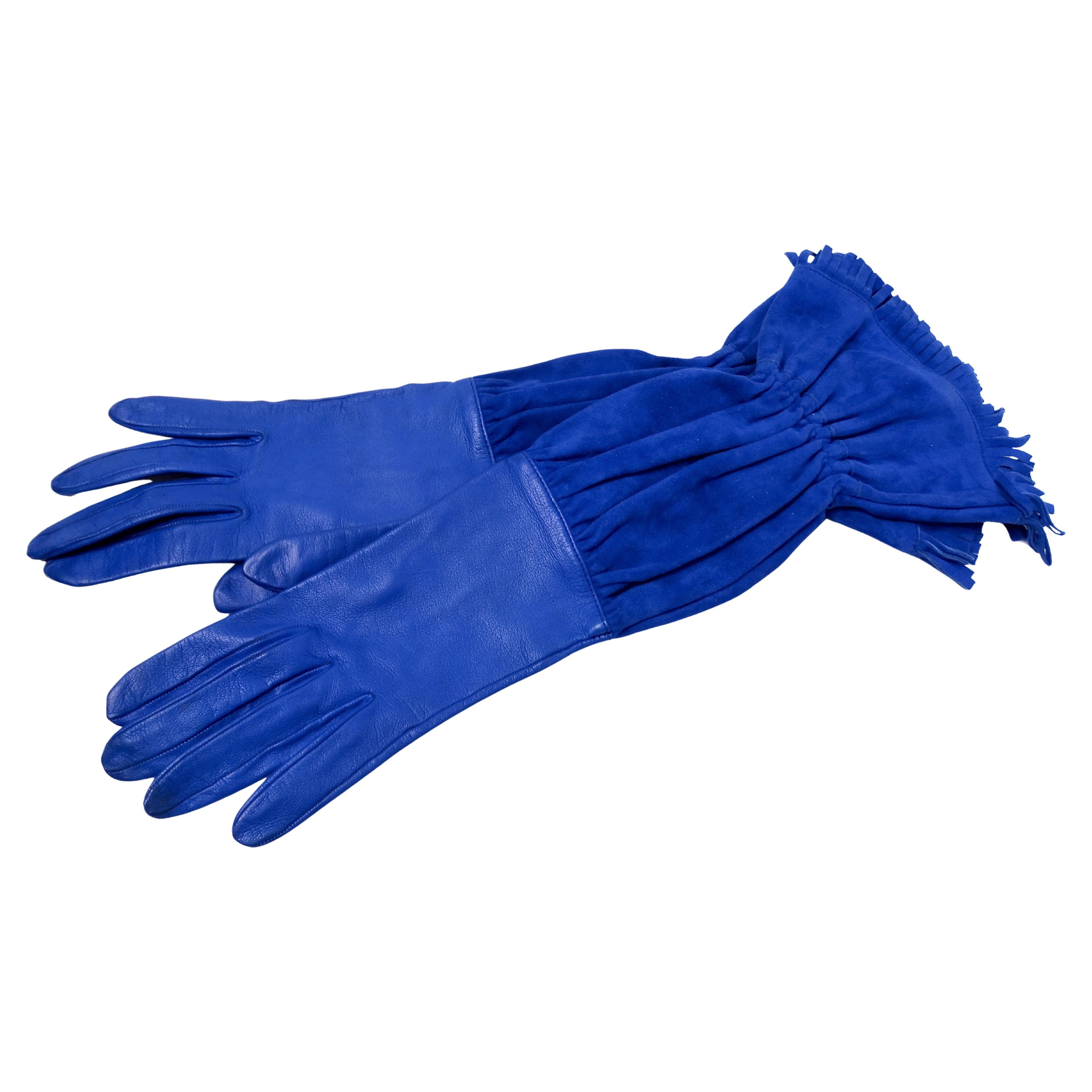 Hermes Electric Blue Leather & Suede Fringe Gloves from the circa 1990s embody a quintessential rider-inspired aesthetic, seamlessly blending luxury with bohemian flair. Crafted from luxurious electric blue leather and soft suede accents, these