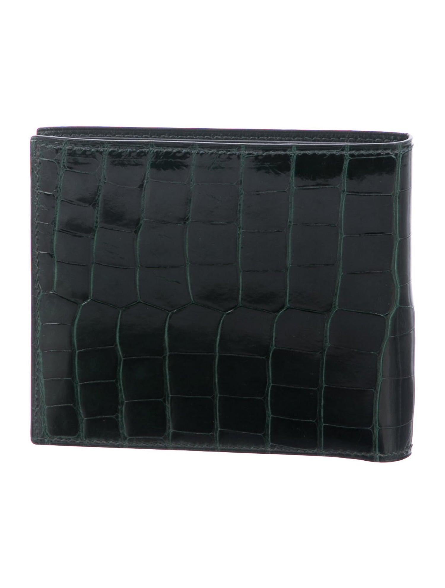 Hermes Emerald Green Alligator Exotic Leather Men's Suit Bifold Bifold Pocket Wallet 

Alligator 
Leather lining
Fold over closure
Features eight interior card slots, dual wall pockets and bill compartment 
Date code present
Made in France
Measures