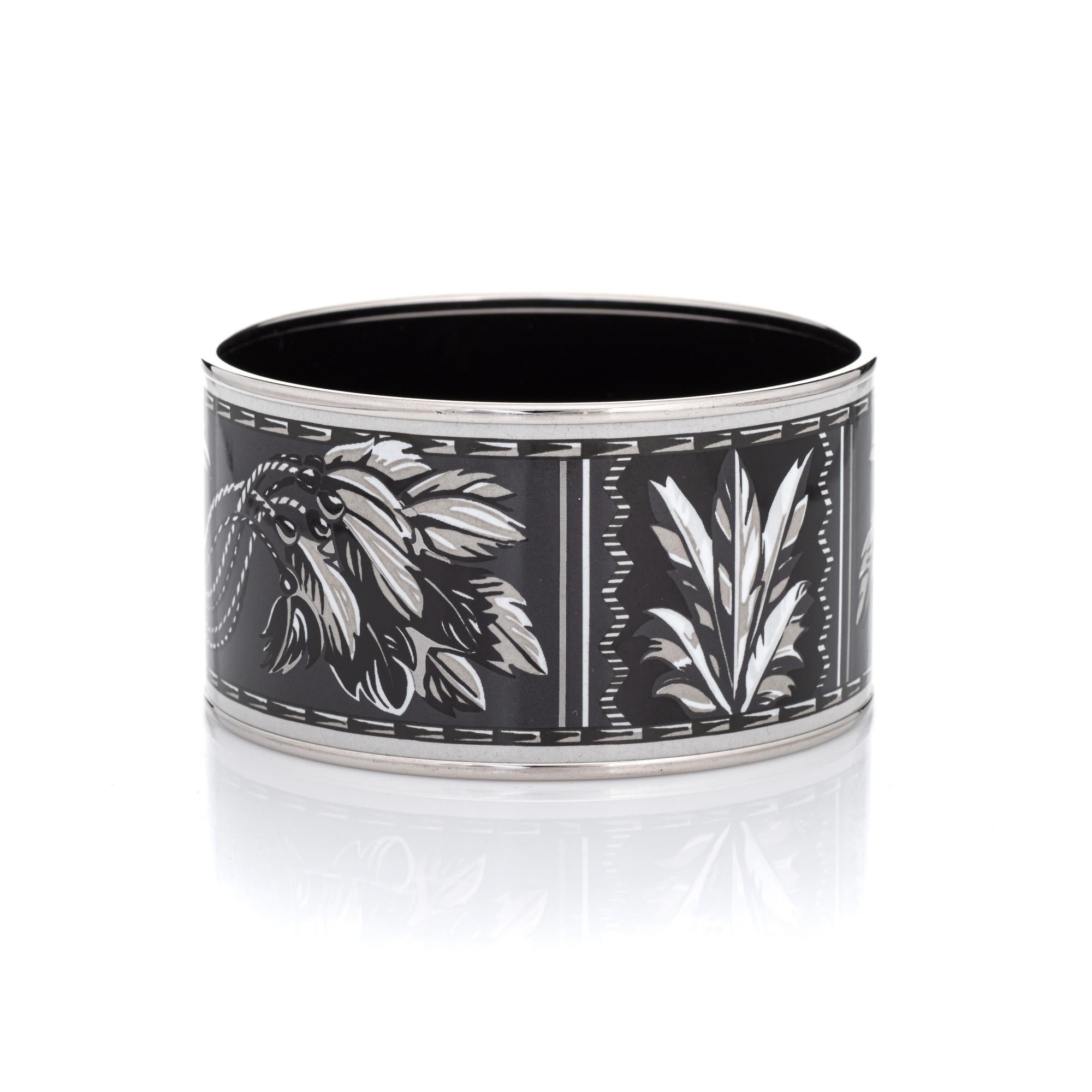 Overview:

Pre-owned Hermes enamel bangle bracelet with a black and white printed feather design and palladium-plated hardware. Also included is the Hermes brown felt travel pouch.

The wide 1.50