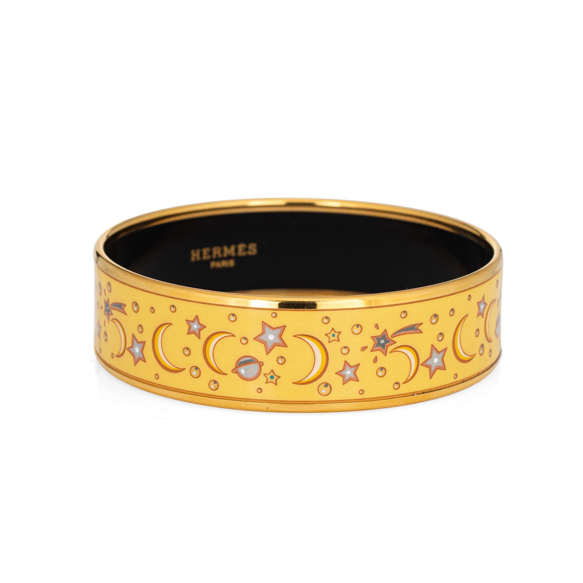 Overview:

Pre-owned Hermes enamel bangle bracelet with a yellow celestial crescent moon and shooting star pattern. 

The wide 0.70