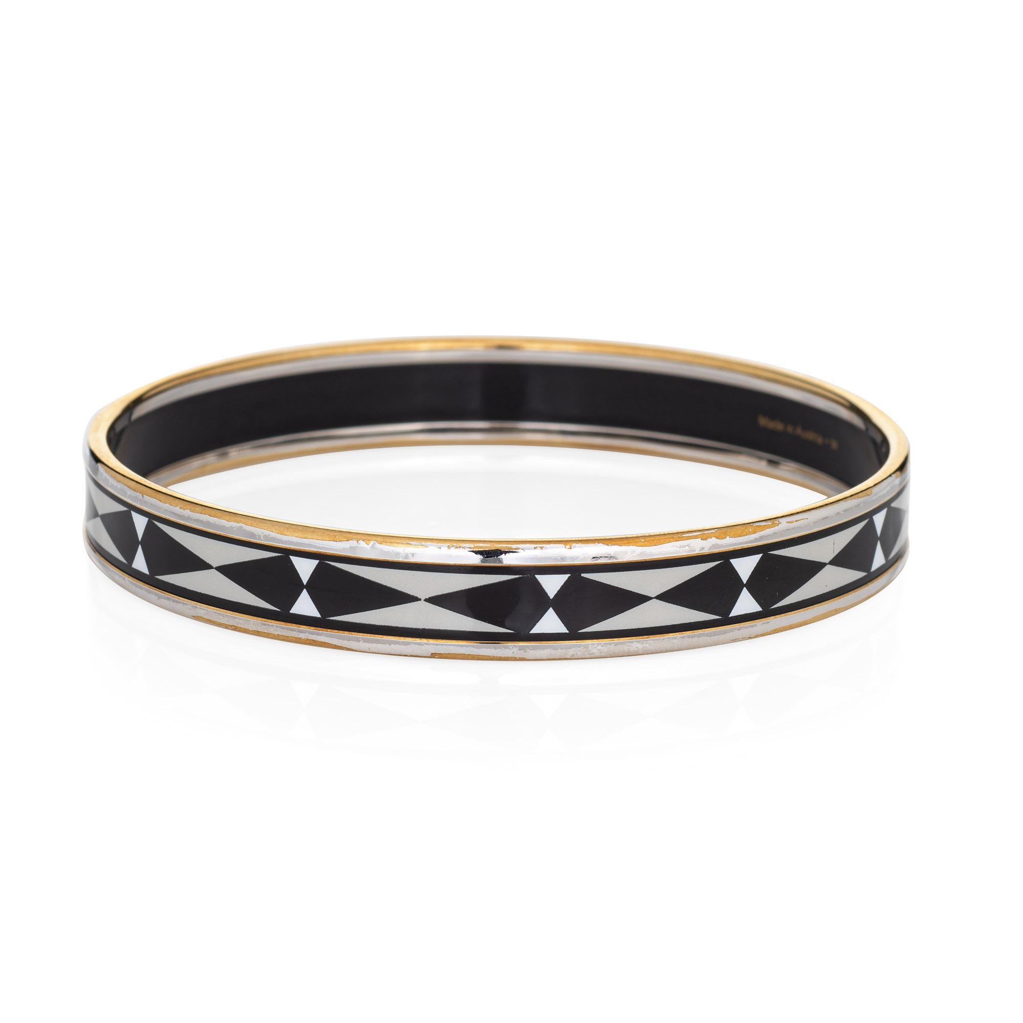 Overview:

Pre-owned vintage Hermes enamel bracelet with a black and white enamel pattern and yellow gold plate.

The narrow 0.35