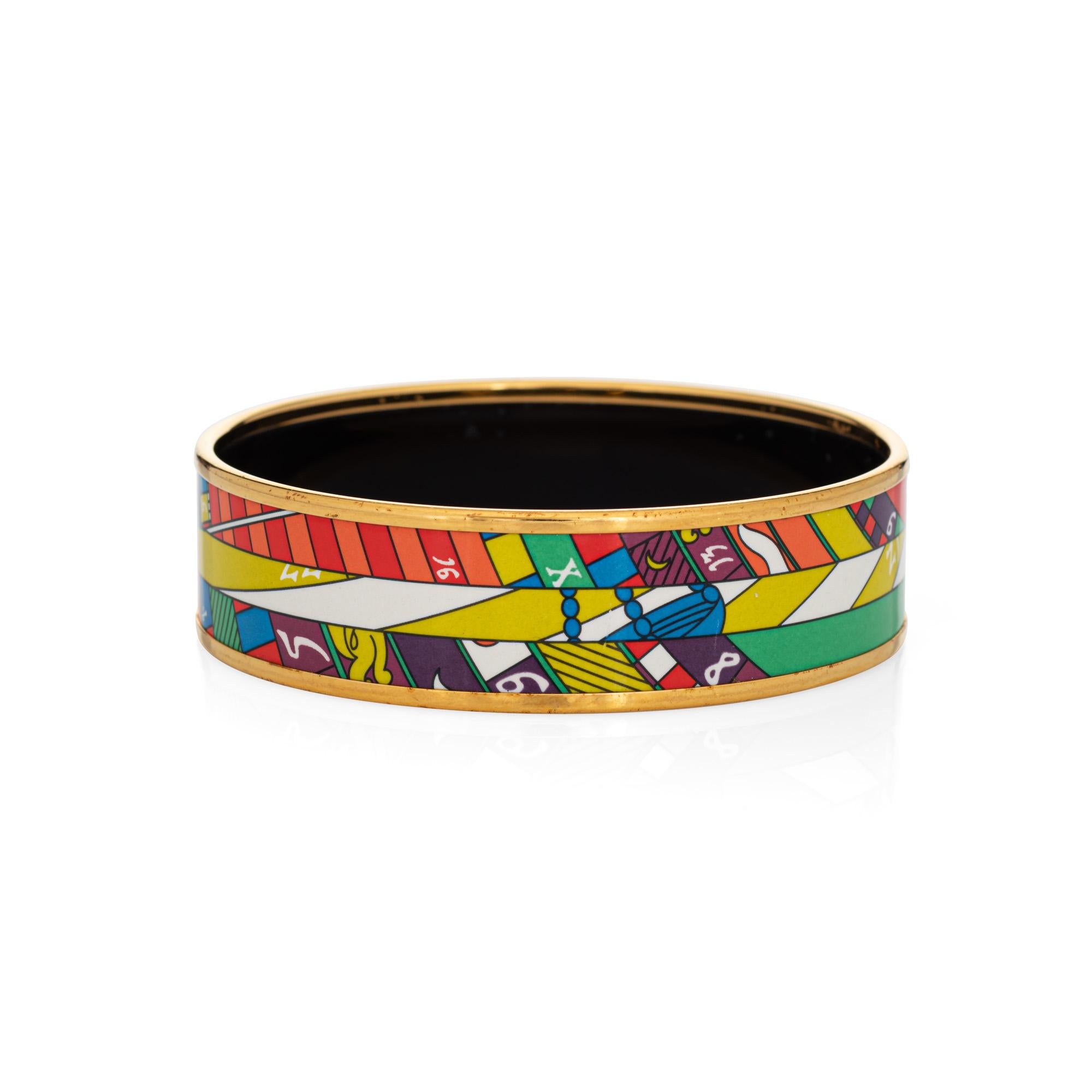 Overview:

Pre-owned Hermes enamel bangle bracelet with a multi-colored print. 

The wide 0.70