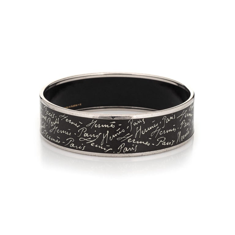 Overview:

Pre-owned vintage Hermes enamel bracelet with a black and white 