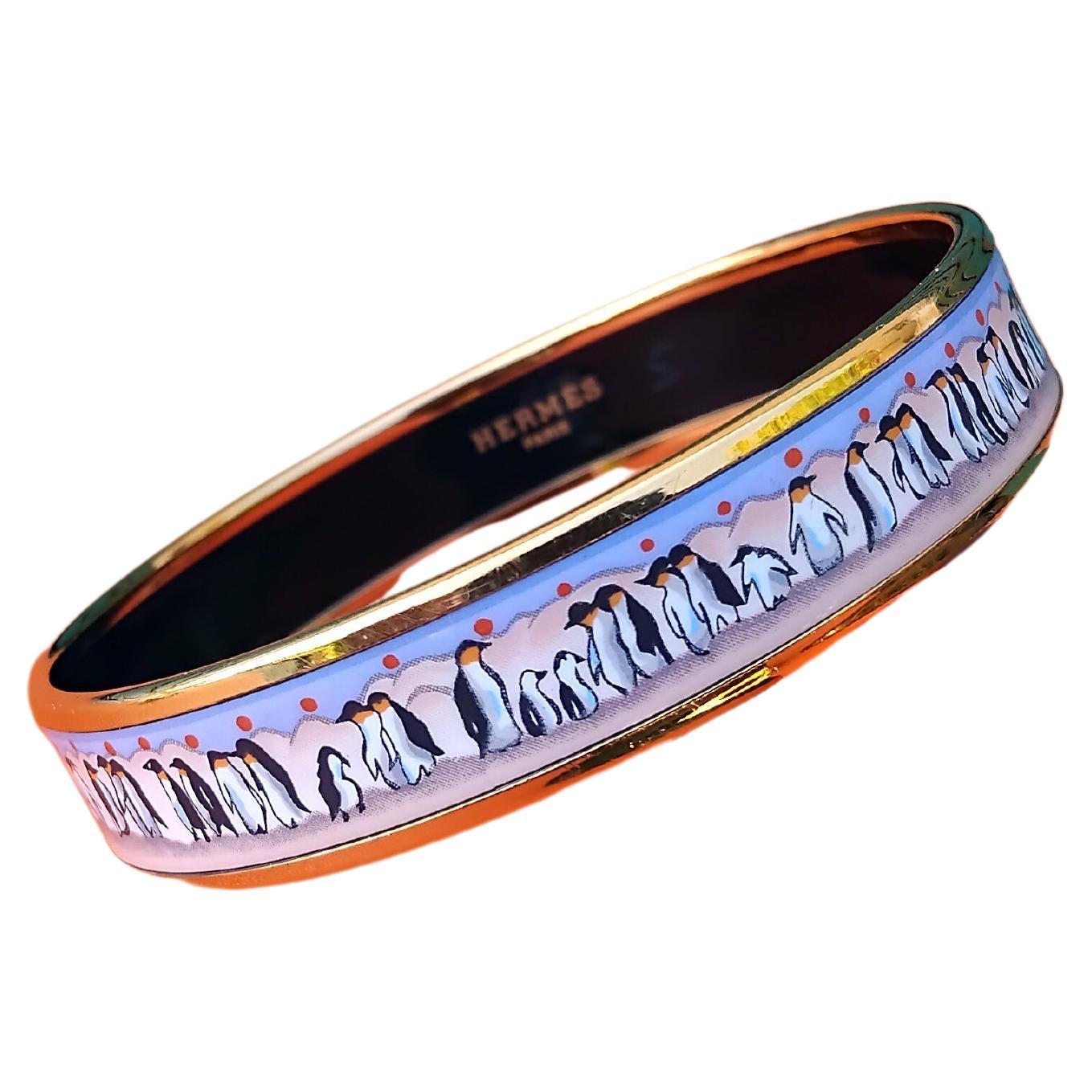 Adorable Authentic Hermès Bracelet

Print: Penguins

Super rare, hard to find !

Made in Austria + E

Made of printed enamel and yellow gold plated hardware

Colorways: 
- Pink and Purple background
- Red polka dots
- White / Black / Yellow