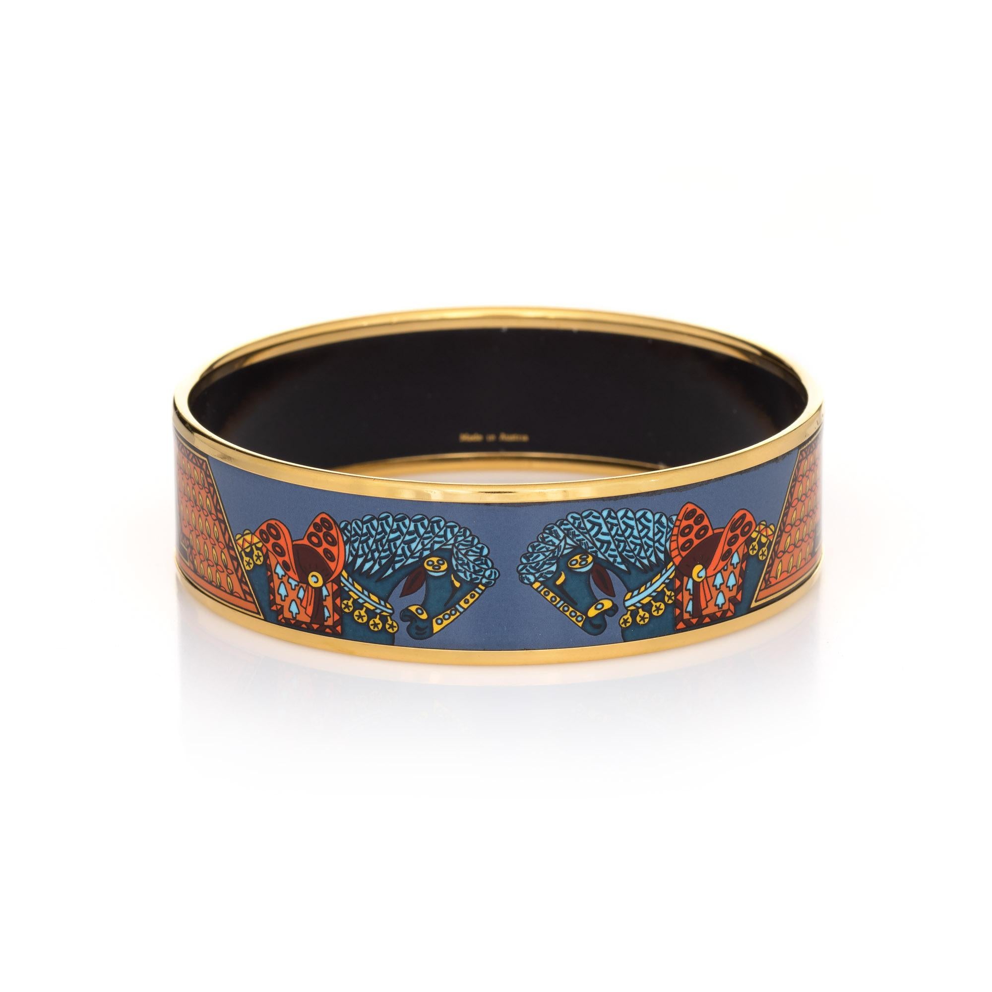Overview:

Pre-owned vintage Hermes enamel bracelet with a blue, orange & turquoise printed equestrian design. 

The wide 0.79