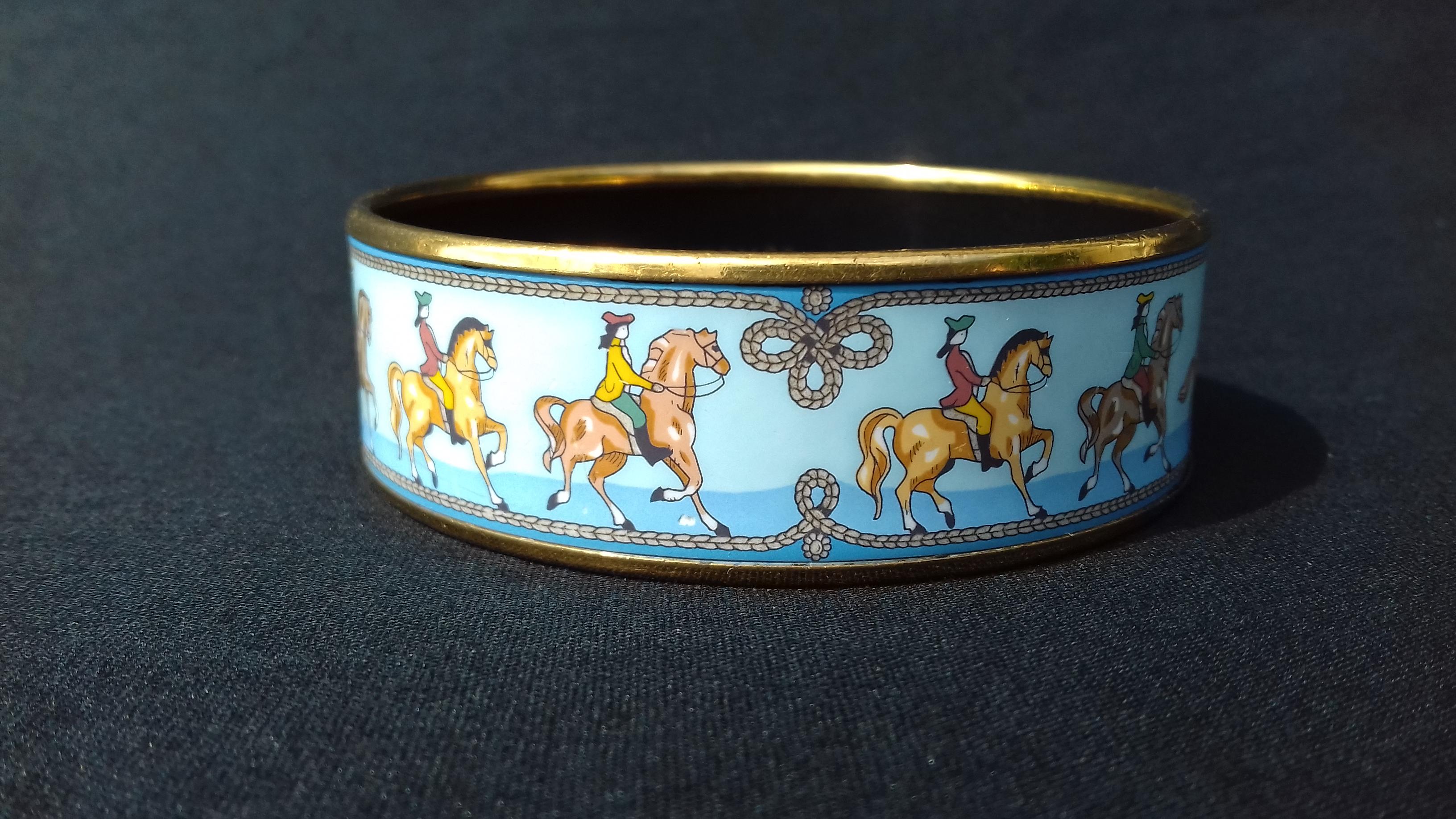 Beautiful Authentic Hermès Bracelet

Pattern: Horses

Made in Austria + E (2001)

Made of Printed Enamel and Gold Plated Hardware

Colorways: Light Blue background, Horses in shades of Beige, Caramel, Brown

