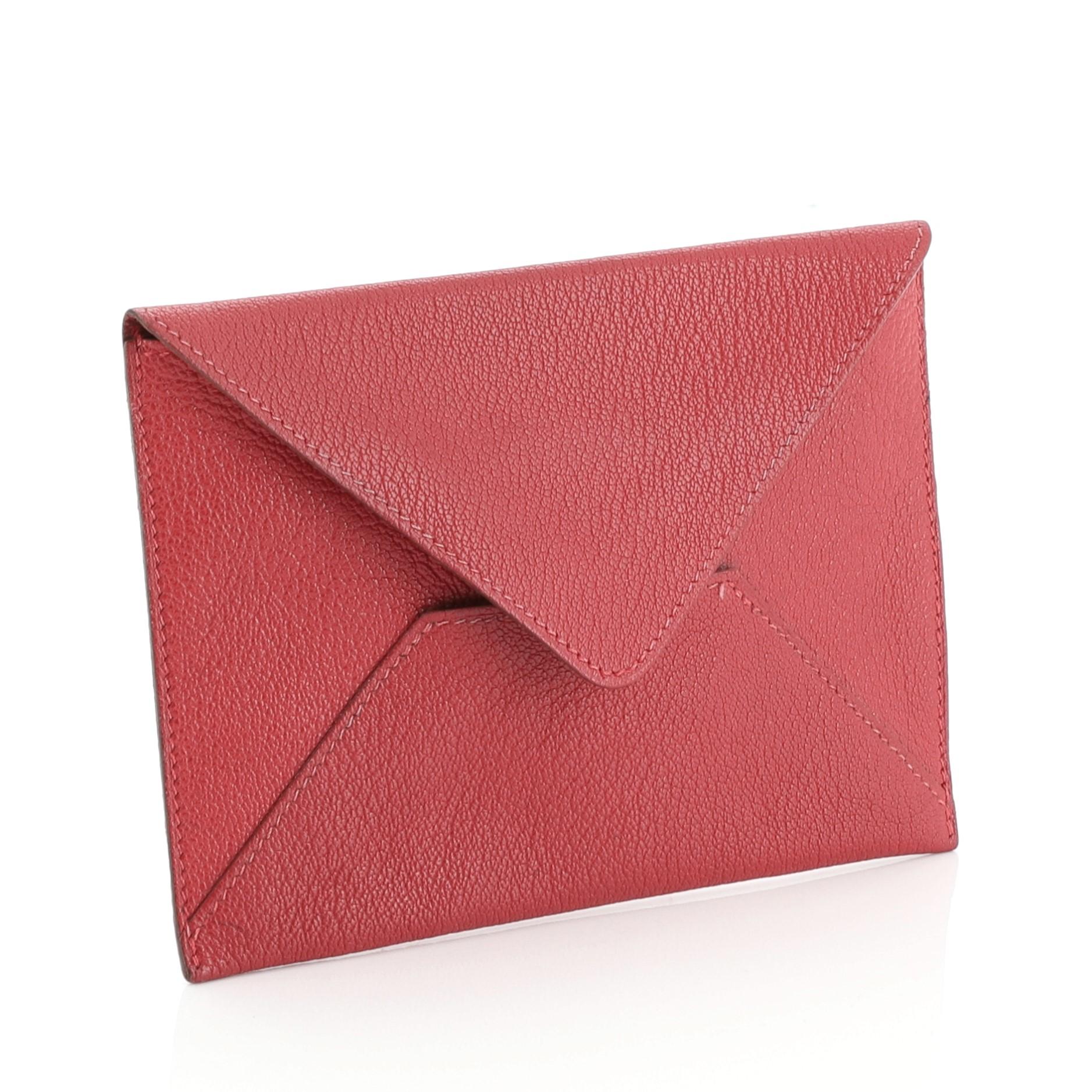 This Hermes Envelope Pouch Leather Large, crafted in Framboise pink Chevre Mysore leather, features an envelope silhouette. It opens to a Framboise pink Chevre Mysore leather interior. Date stamp reads: F Square (2002).

Estimated Retail Price: