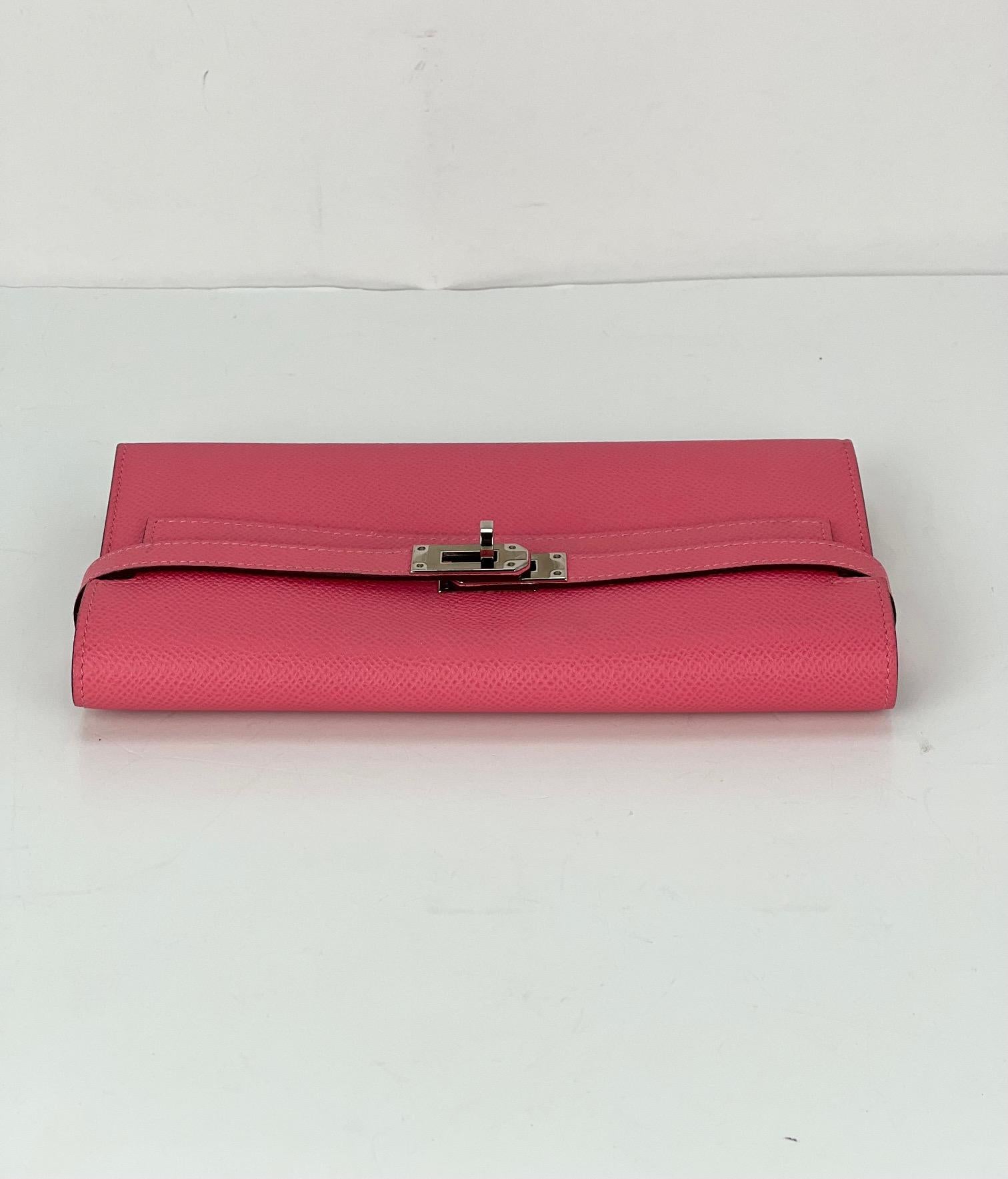 Pre-Owned  100% Authentic
HERMES Epsom Kelly Longue Rose Azalee Wallet  
RATING: A/B...Very Good, well maintained, 
shows minor signs of wear
MATERIAL: textured calfskin leather
COLOR: rose azalee, pink  
EXTERIOR: on front of right strap has a tiny
