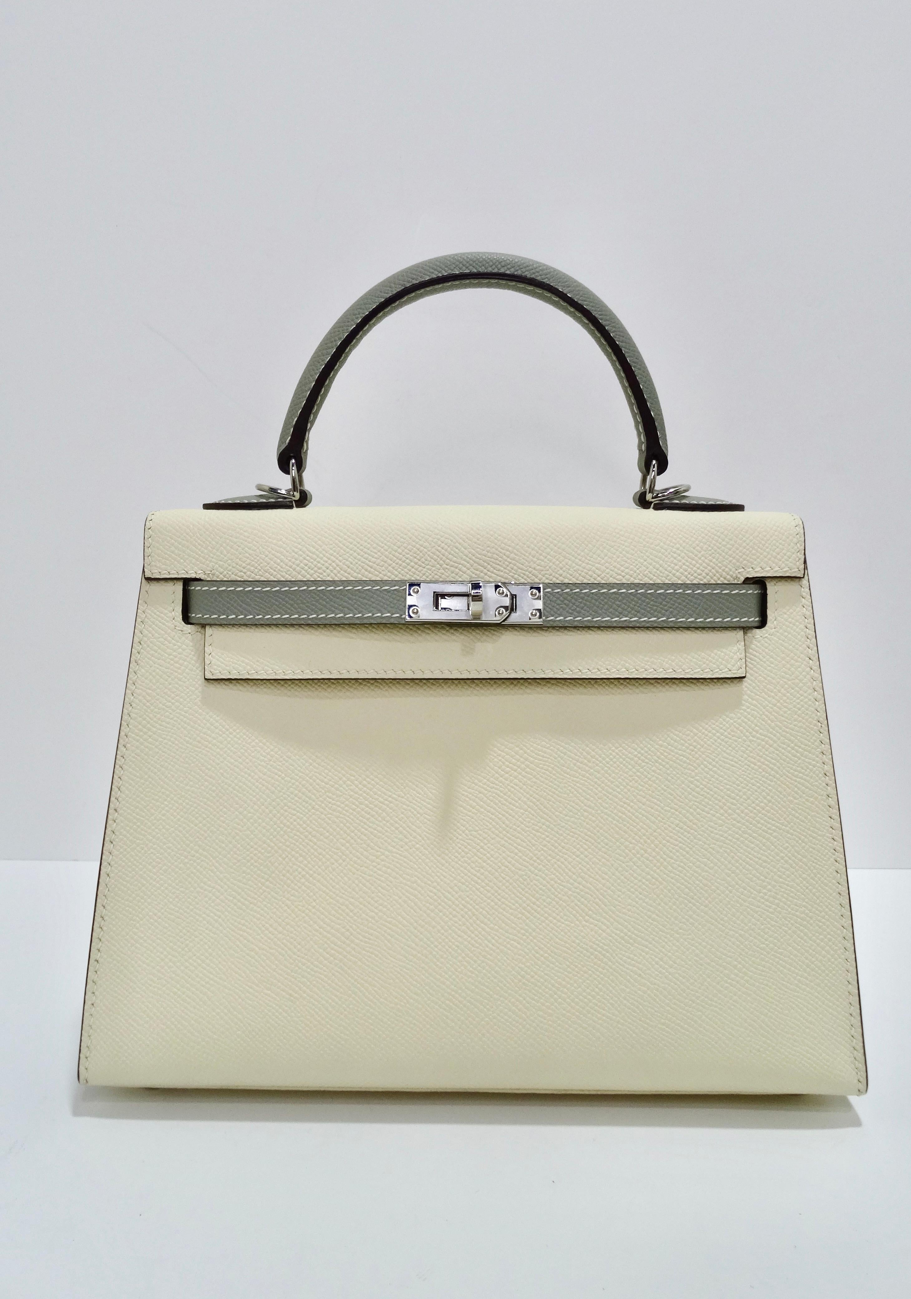 This Hermès Epsom Mini Horseshoe Kelly Sellier 25cm Craie Gris Asphalte is nothing short of beautiful. This stunning Hermes classic handbag is beautifully crafted in stamped epsom calfskin leather in off white and gray. A single rolled leather top
