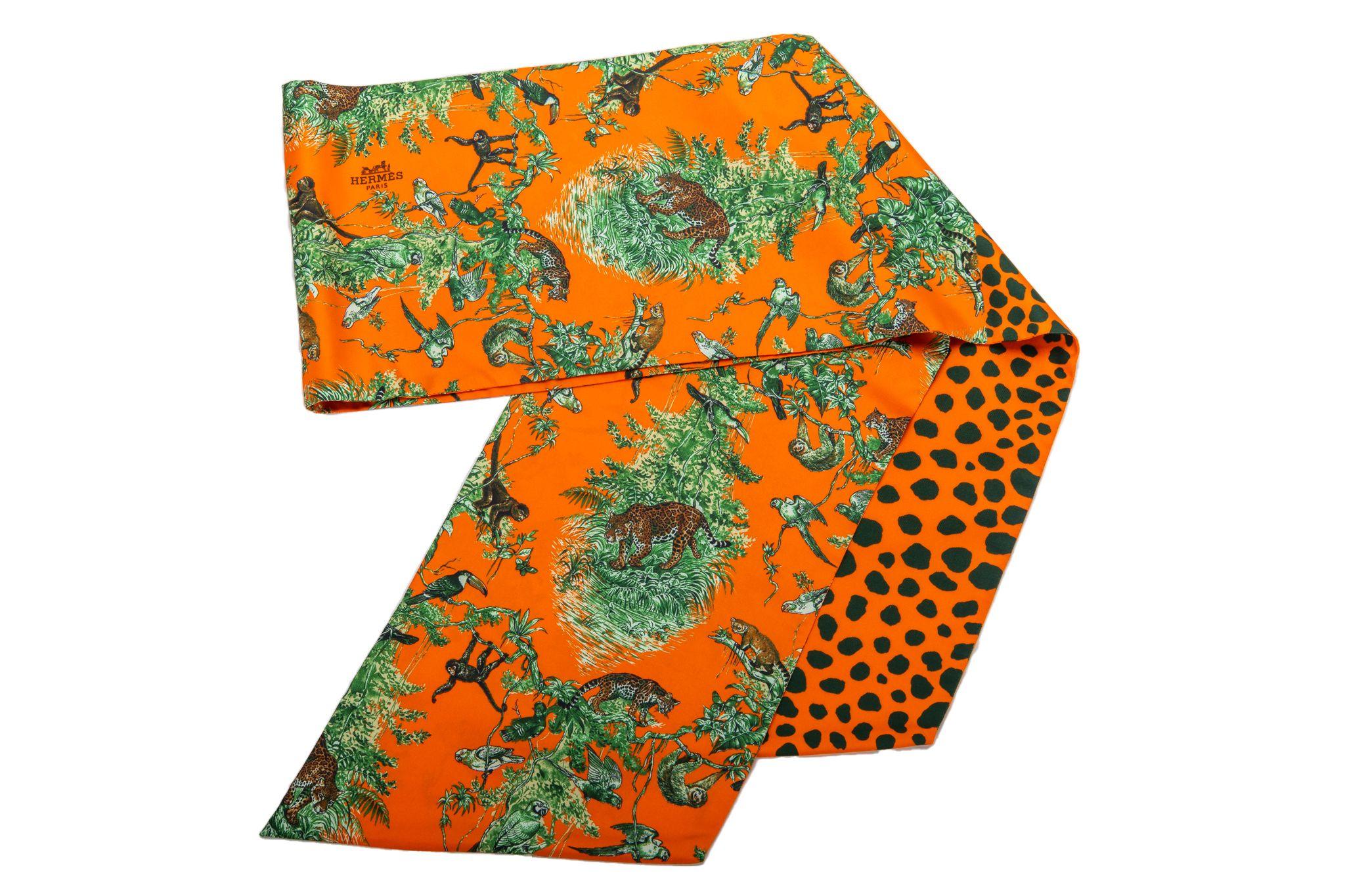 Hermès Equateur Orange maxi twilly scarf with feather floral detail. Hand-rolled edges. Discontinued size. New in box.

