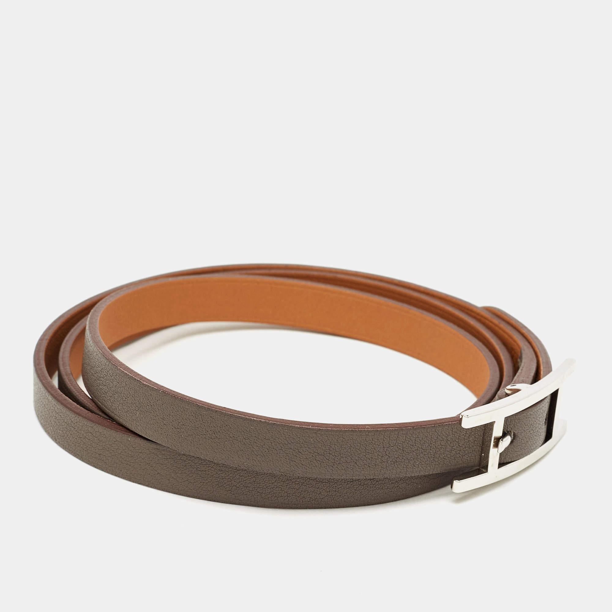The Hermes bracelet is a luxurious and stylish accessory that exudes timeless elegance. Crafted from supple Swift leather, this bracelet features a sleek and minimalist design with a silver-tone H-shaped clasp. The rich color and fine craftsmanship