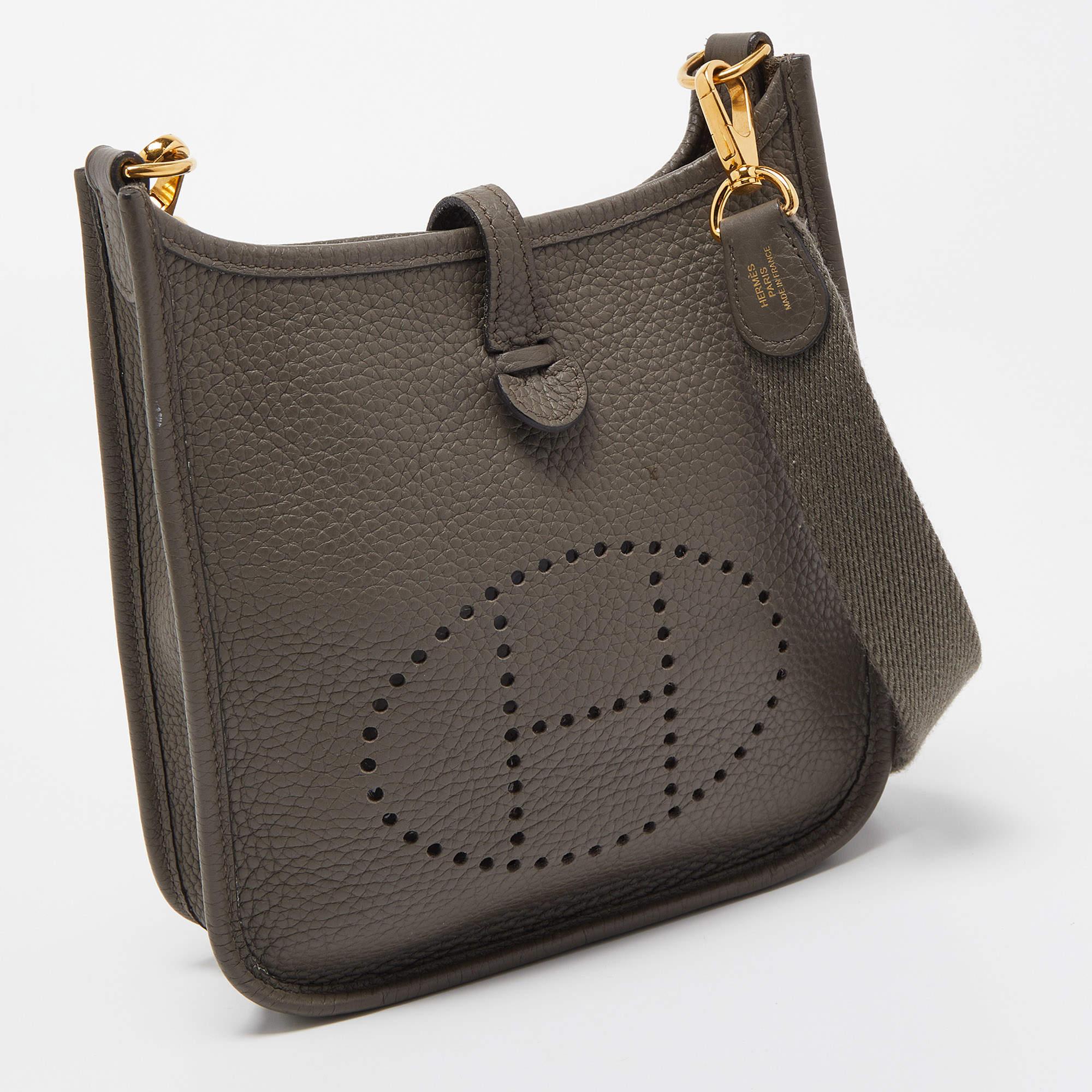 The Evelyne is another investment-worthy bag from Hermès. This one here is crafted from Taurillon Clemence leather and detailed with the signature elements of the leather tab closure, the saddle-like shape, and the perforated H on the front. The bag