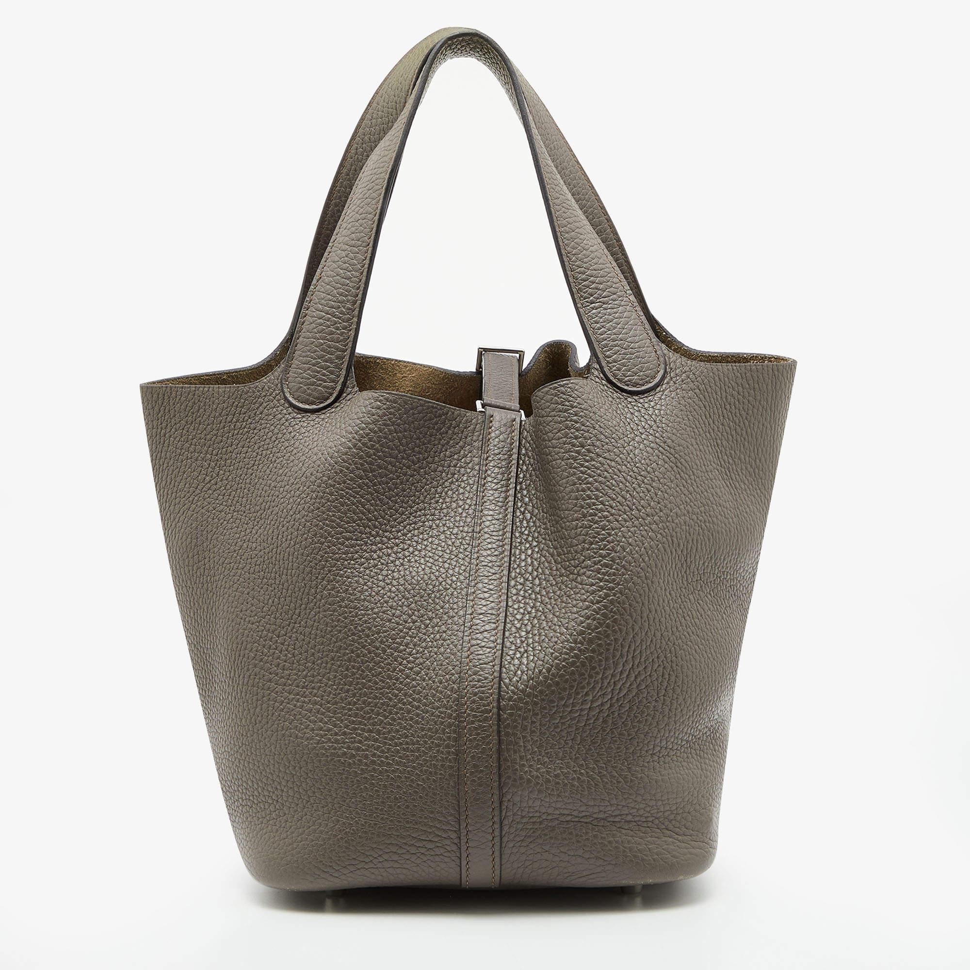 Wonderfully crafted from leather, this Picotin from Hermes is a creation for people who love a perfect blend of luxury and style. It comes in a classy hue, and it sits in a relaxed shape with two handles and a spacious interior. Armed with