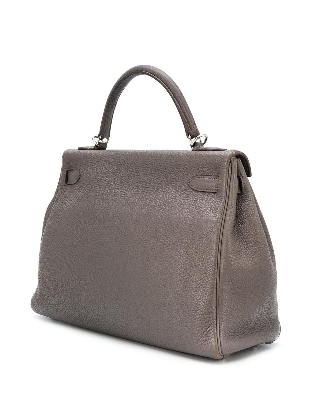 This 32cm Kelly Retourne bag from Hermès is a true testament to the quality of the house's craftsmanship, exuding timeless style and elegance. Crafted in France from smooth togo leather, a favoured Hermès hide for its fine-grained texture and